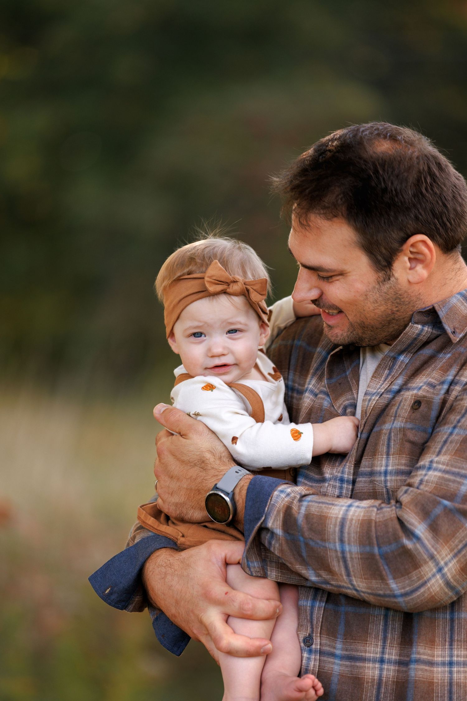 A series of candid moments showing a parent playfully interacting with a baby outdoors in autumn light.