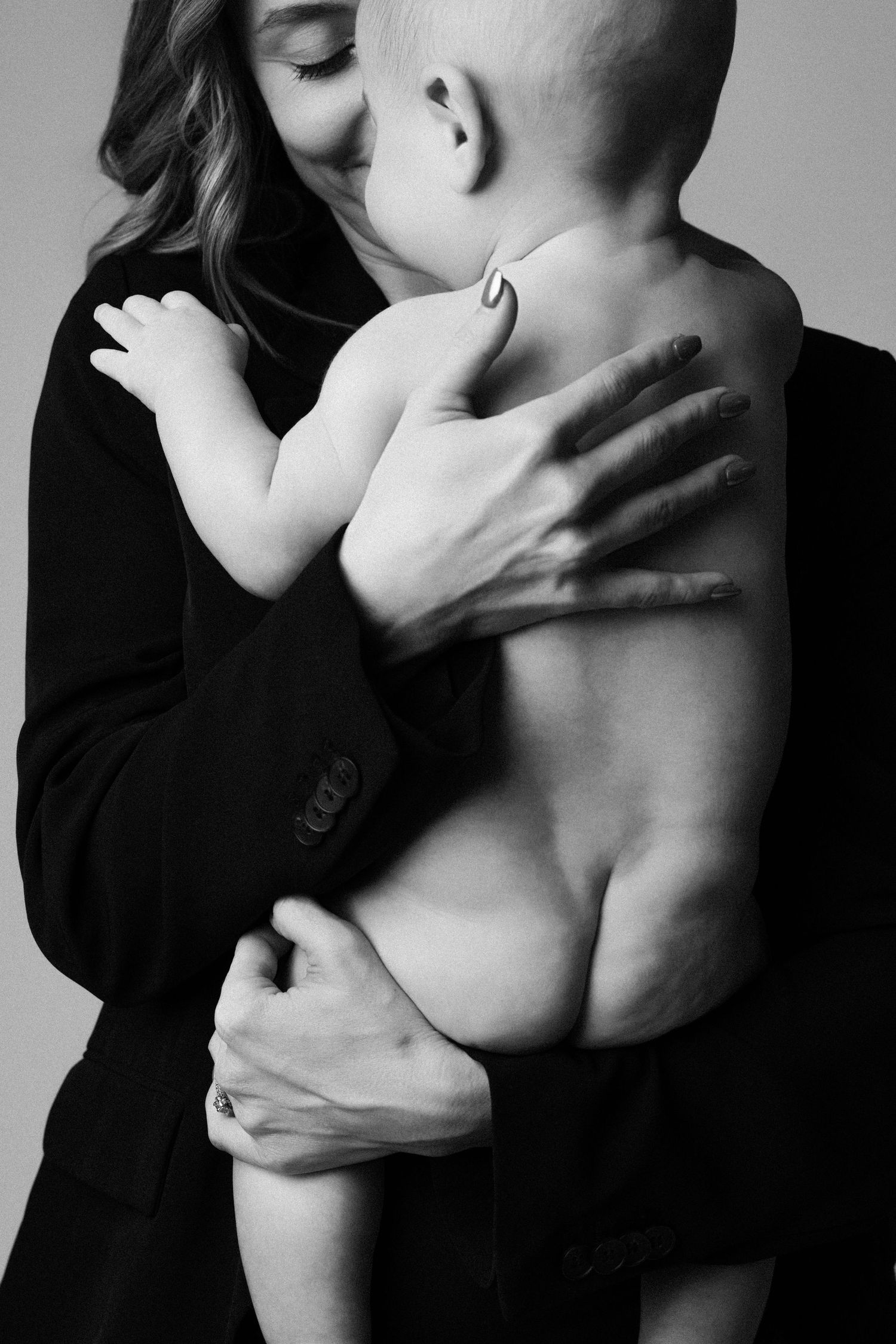Black and white artistic photo series showing intimate embrace between two figures against stark background.