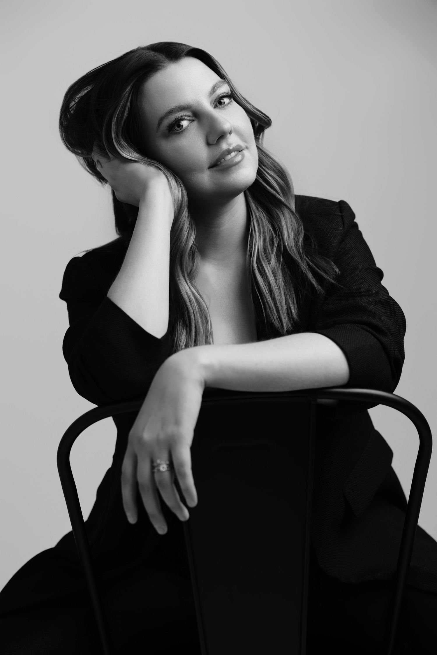 Artistic black and white portraits showing contemplative poses on a chair.