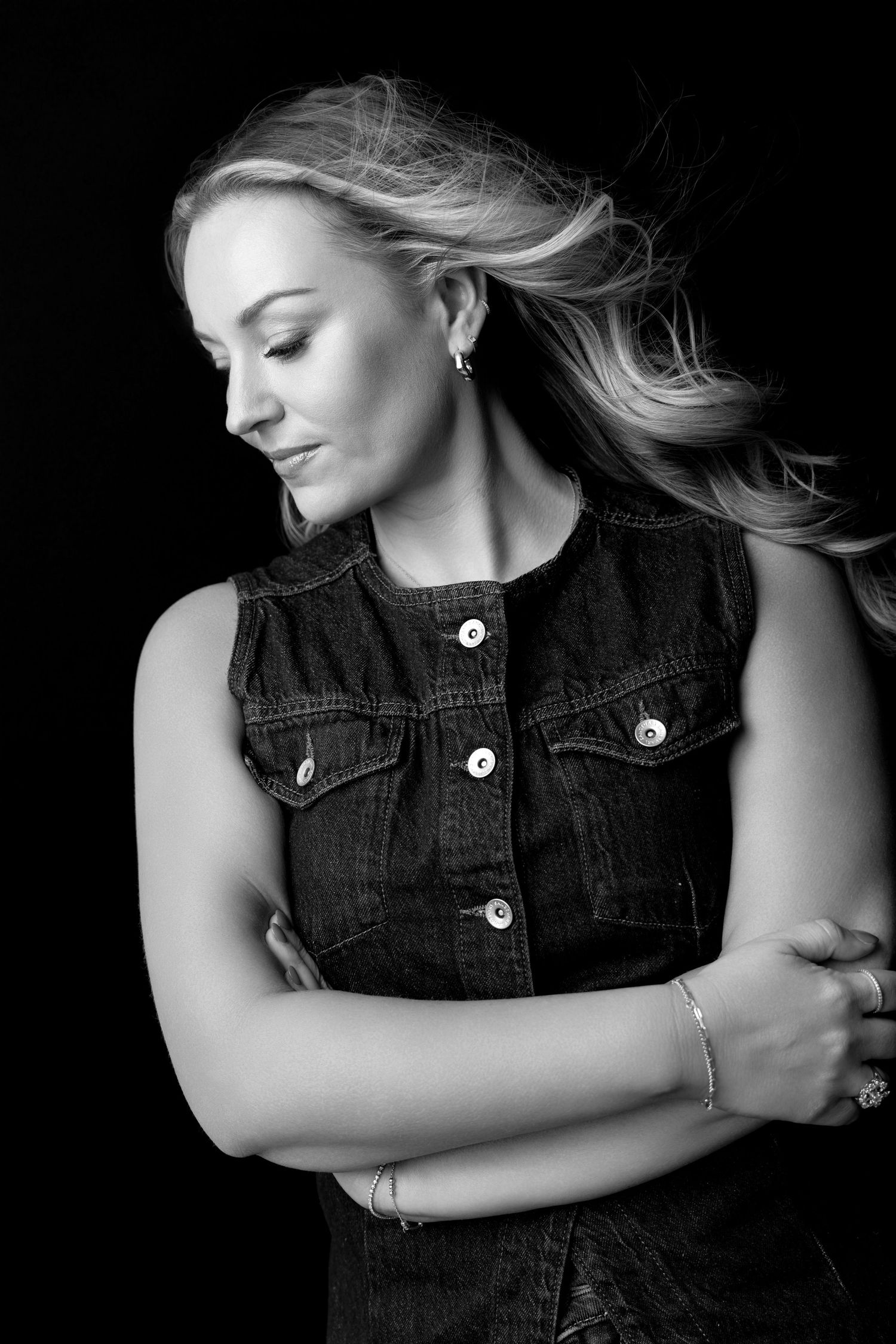 Artistic black and white portraits in denim vest showing elegant poses.