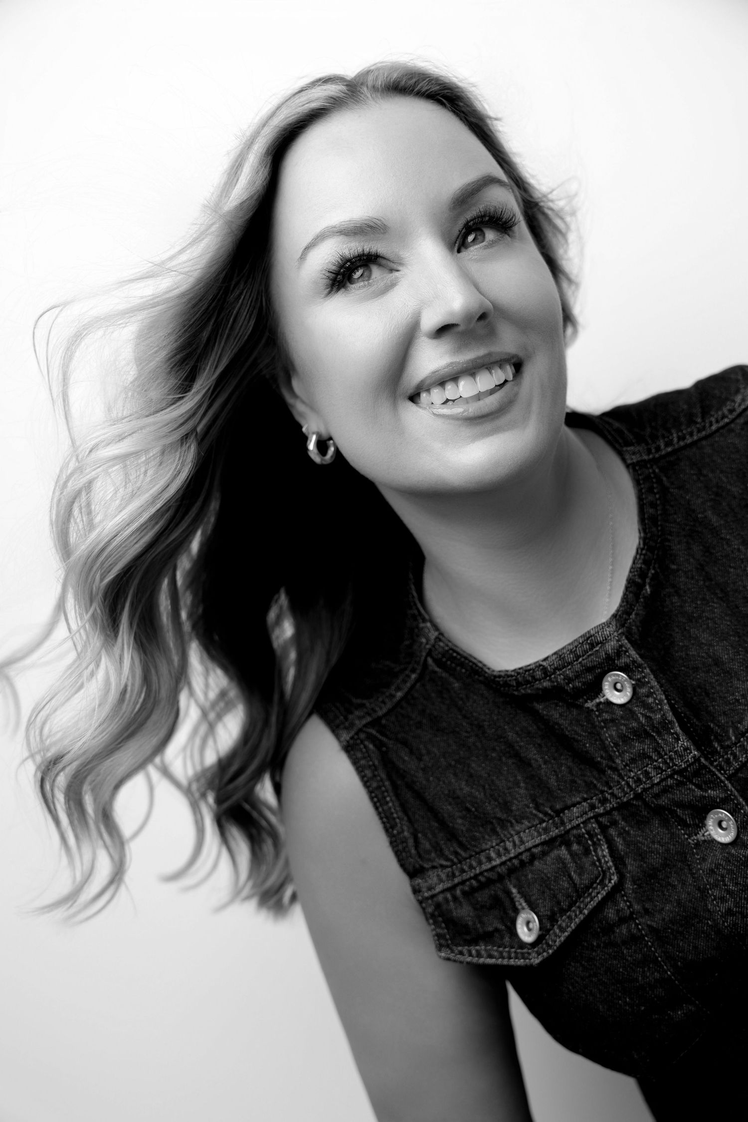 Black and white portrait series showing carefree movement in denim jacket.