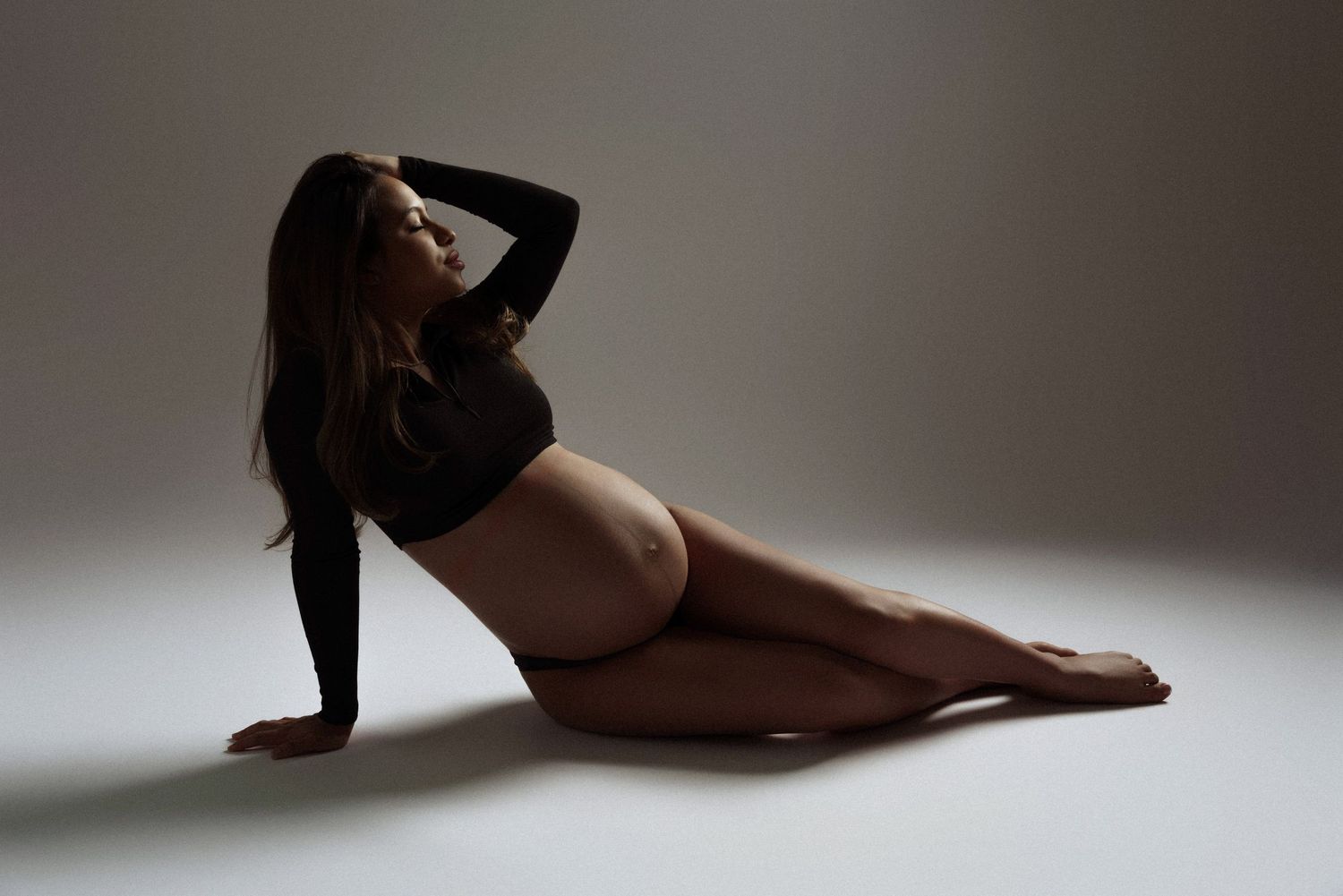 Artistic black and white photo series showing graceful ballet dancer poses in dramatic lighting and shadows.