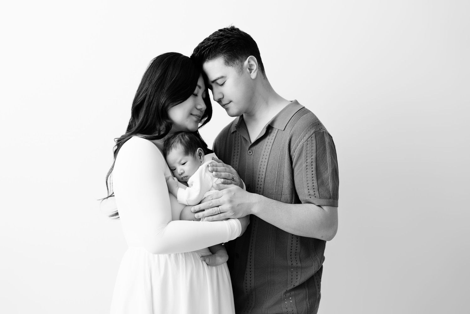 Intimate black and white portrait of couple embracing in a tender moment.