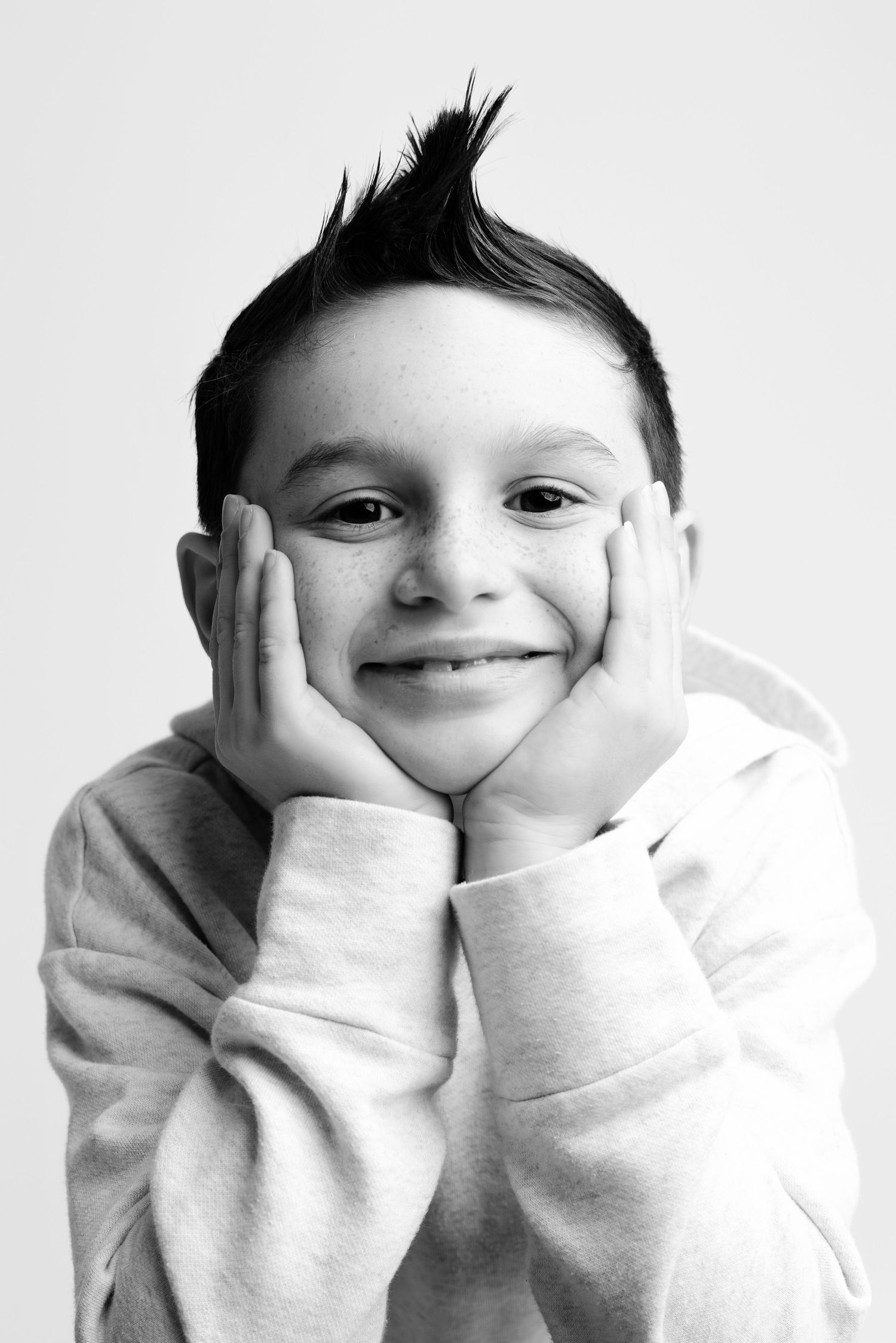 Black and white portraits showing sweet expressions while resting head on hands.
