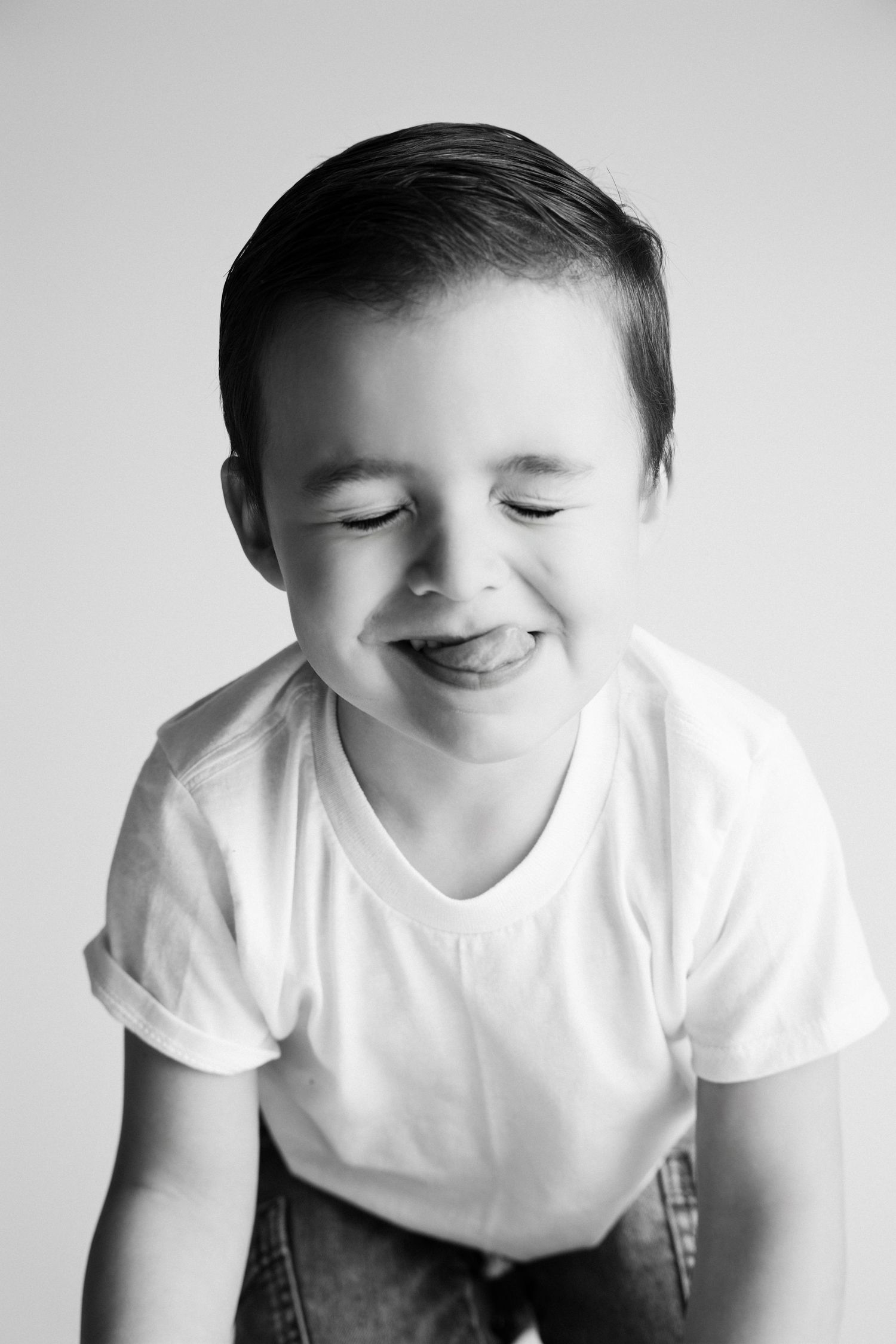 Candid black and white portrait series showing natural smiles and expressions.