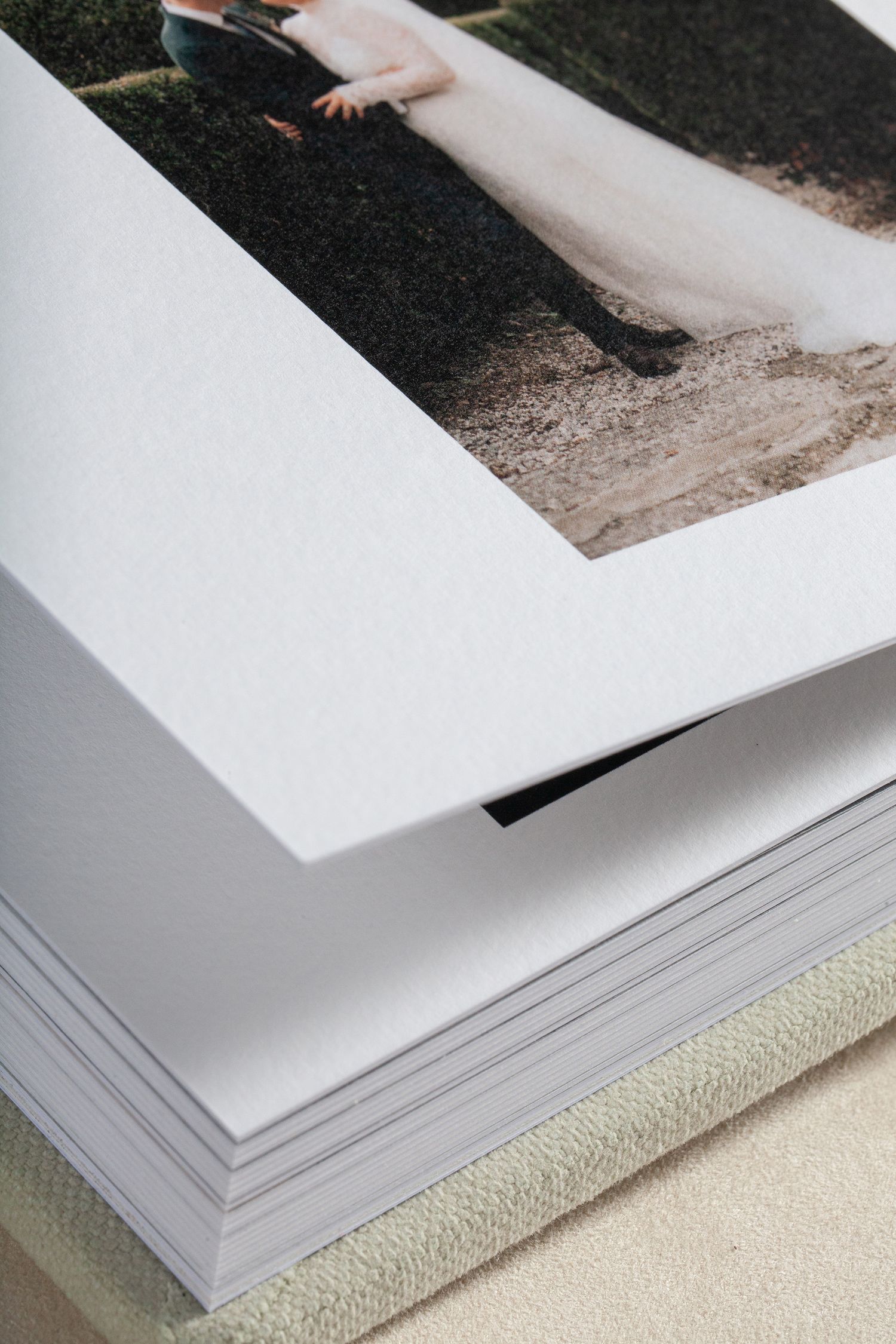 Close-up of white photo mat edges showing layered paper texture.