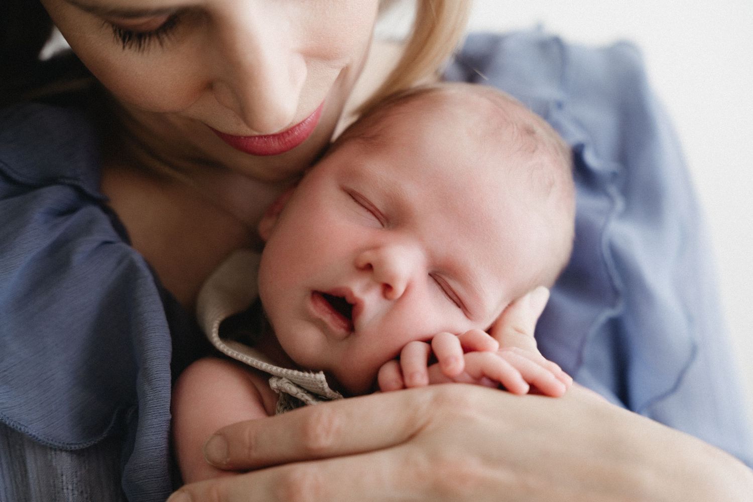 Close-up series of tender moments between parent and baby showing gentle kisses and nurturing affection.
