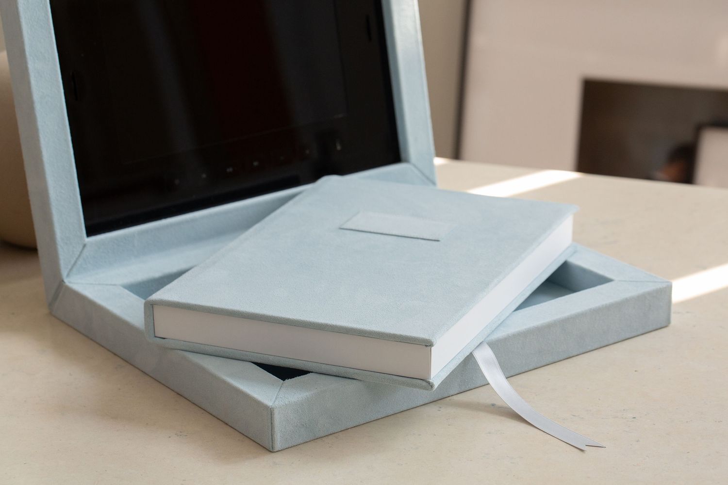 Series of pale blue geometric folded paper forms photographed on white surface.