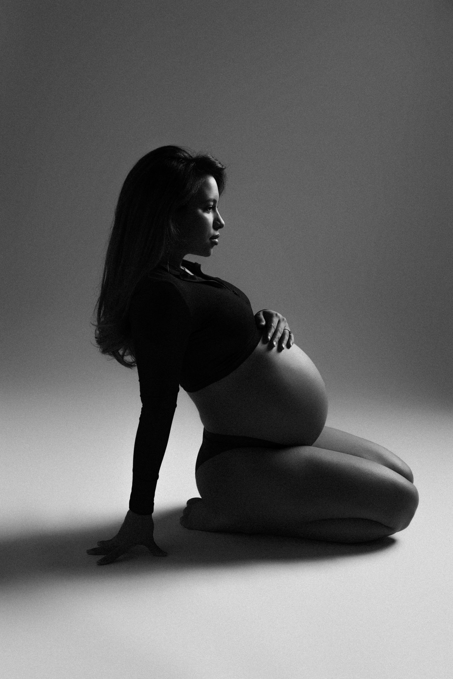 A series of artistic black and white nude silhouettes showing graceful poses against a light background.