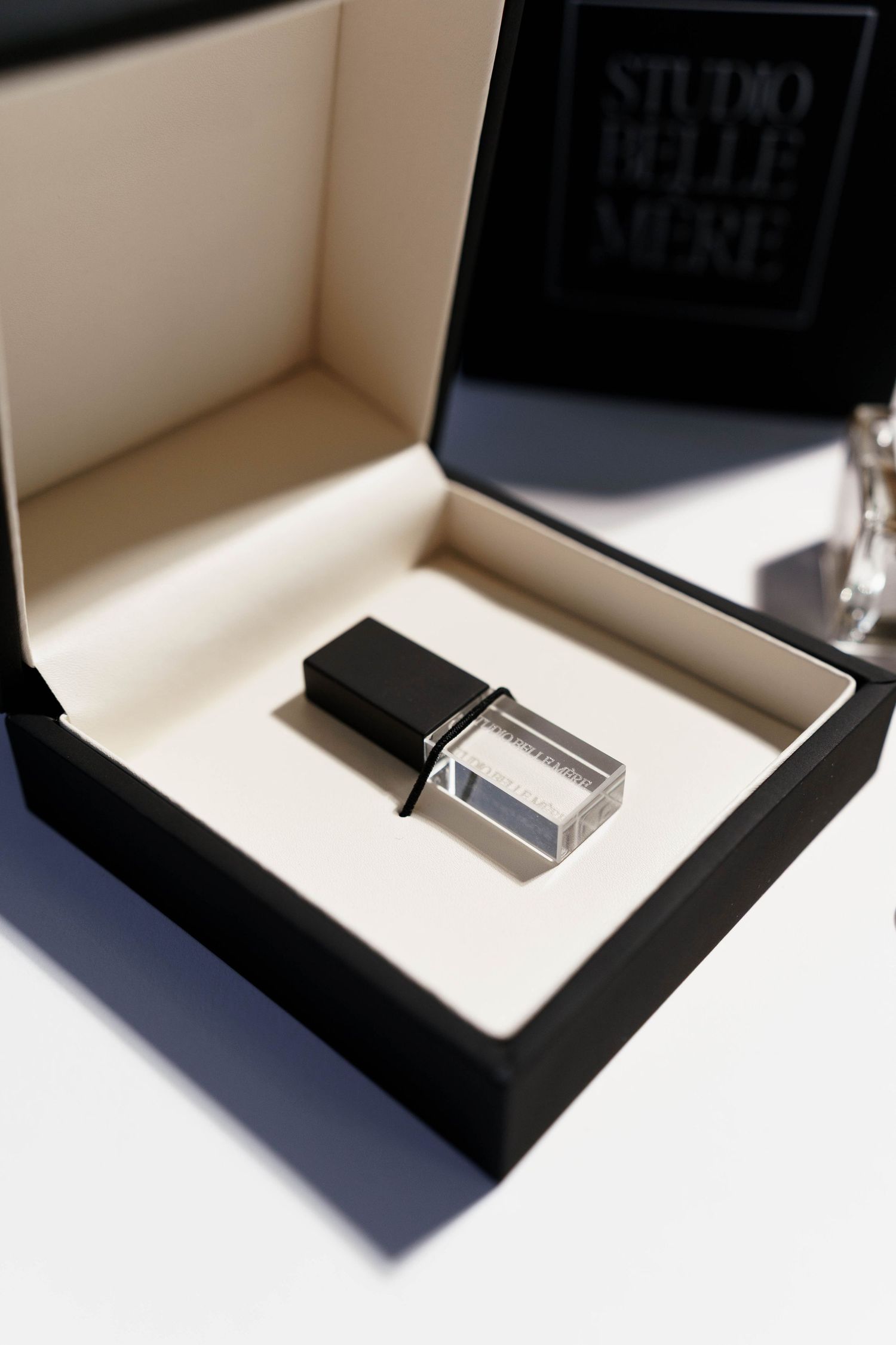Luxury perfume packaging presentation in black and white display box.