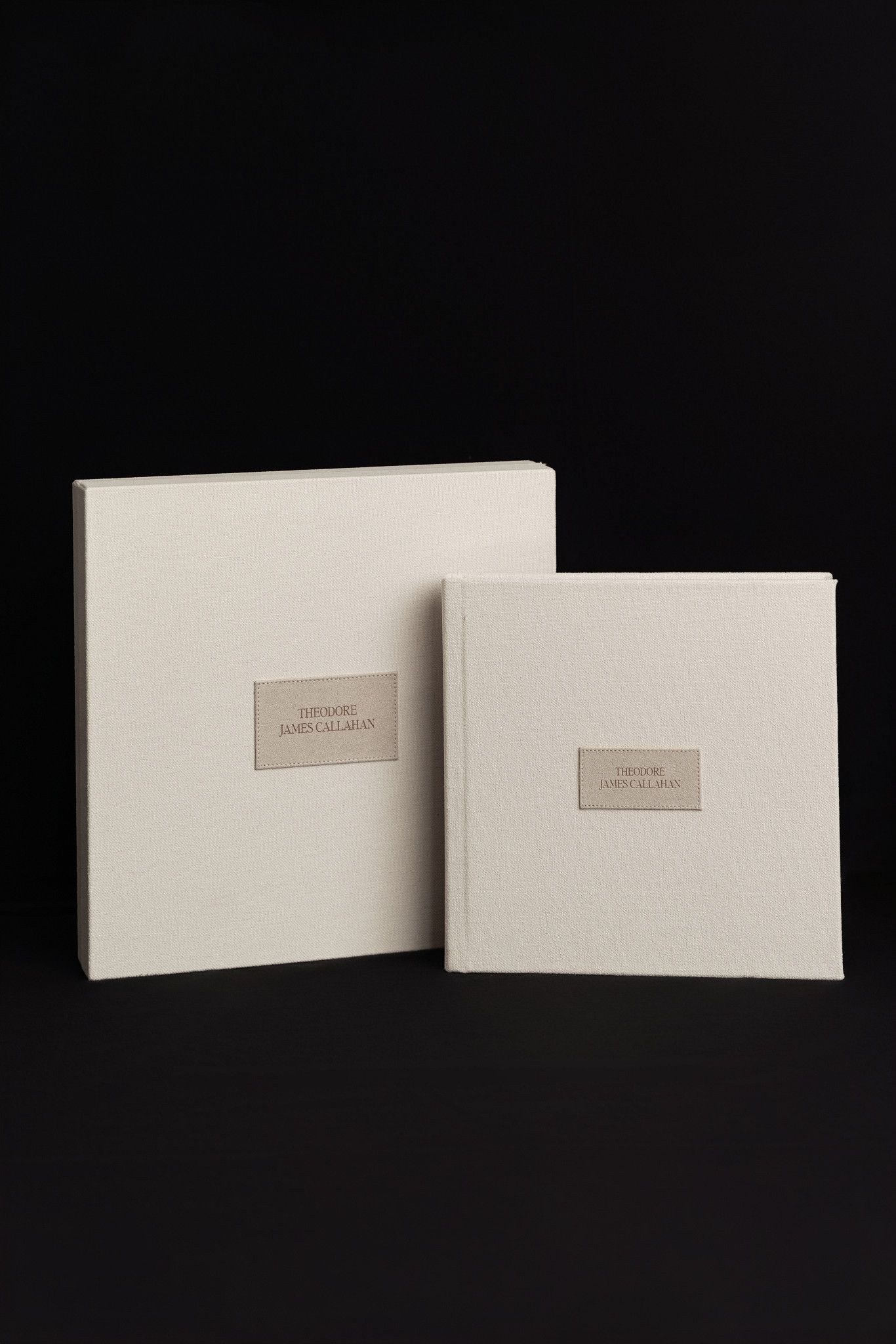 Four minimalist white paper or cardstock envelopes arranged in different angles against a black background.