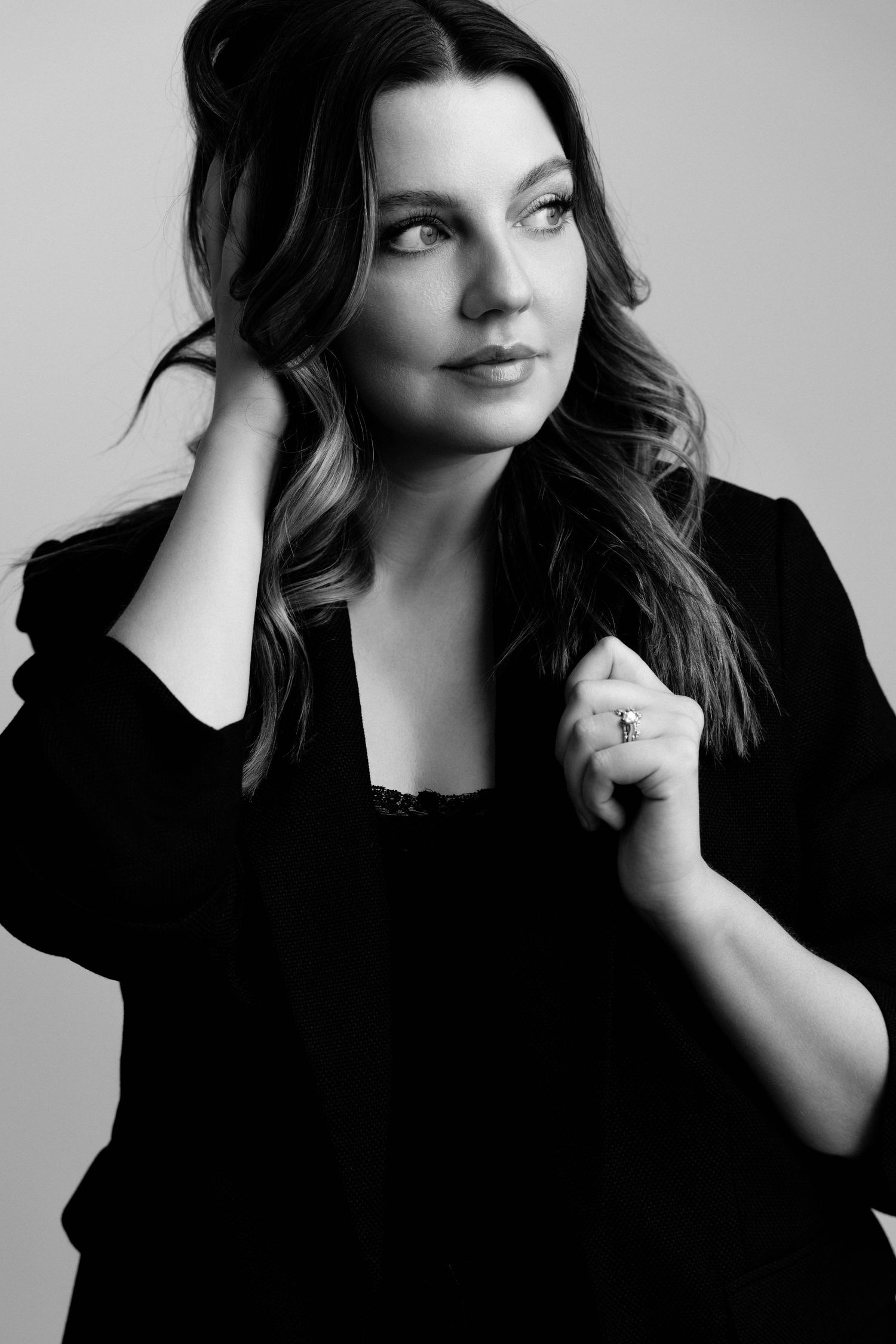 Series of expressive black and white portraits featuring dramatic lighting and dark clothing.