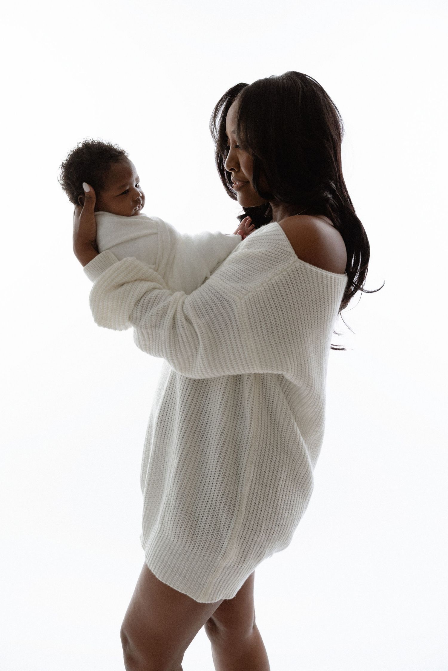 Sequence of a person in white sweater and underwear dancing and posing against white background.