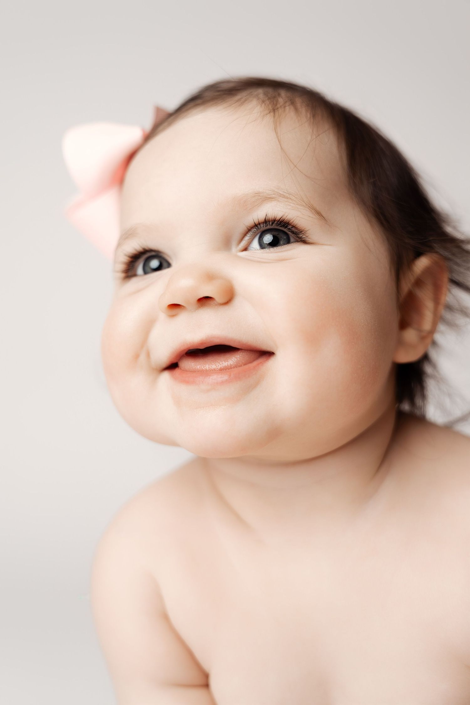 Series of close-up photos showing a baby's delicate facial features and expressions against a light gray background.