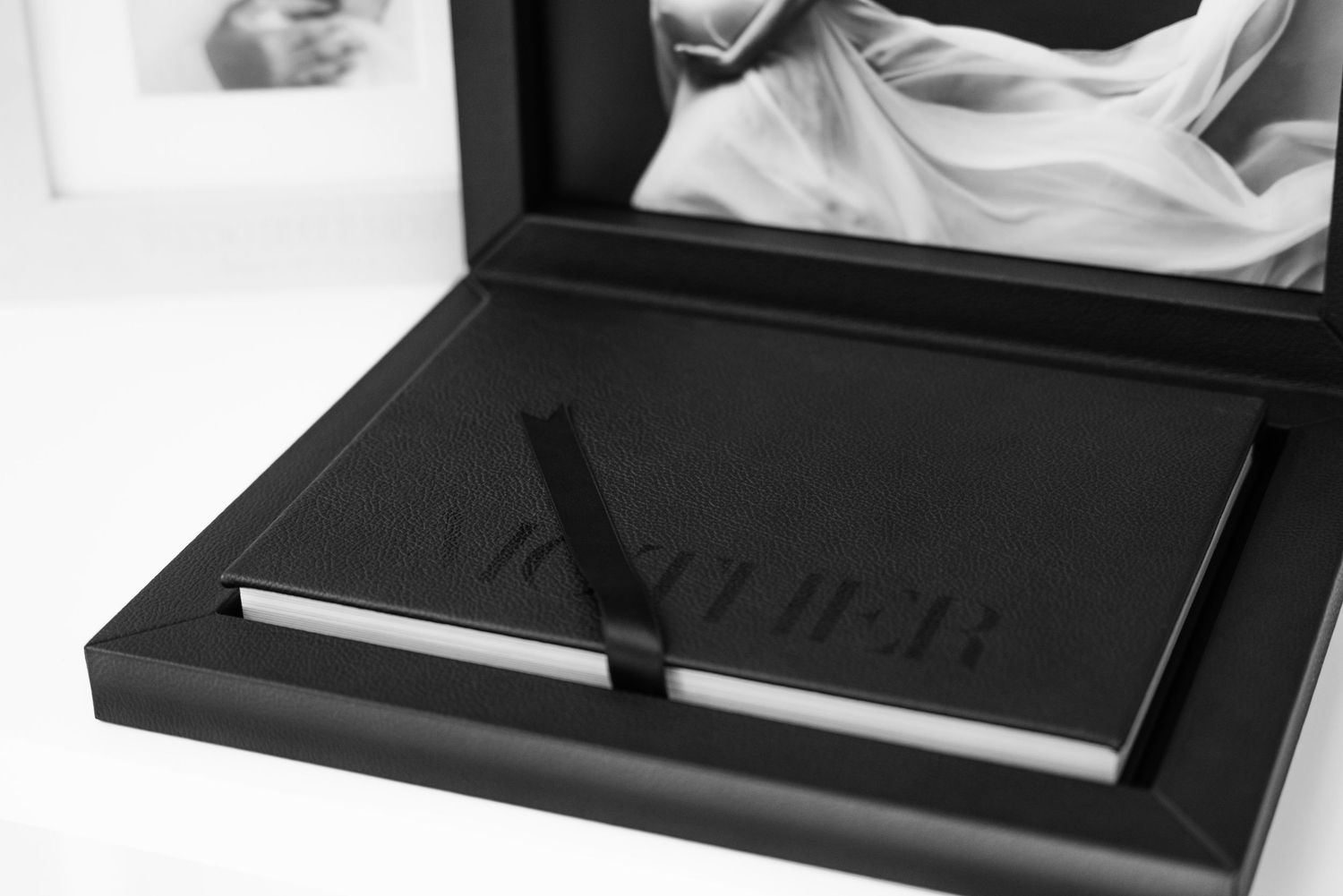 Black leather wallet and pen set displayed in an elegant gift box presentation with white interior padding.