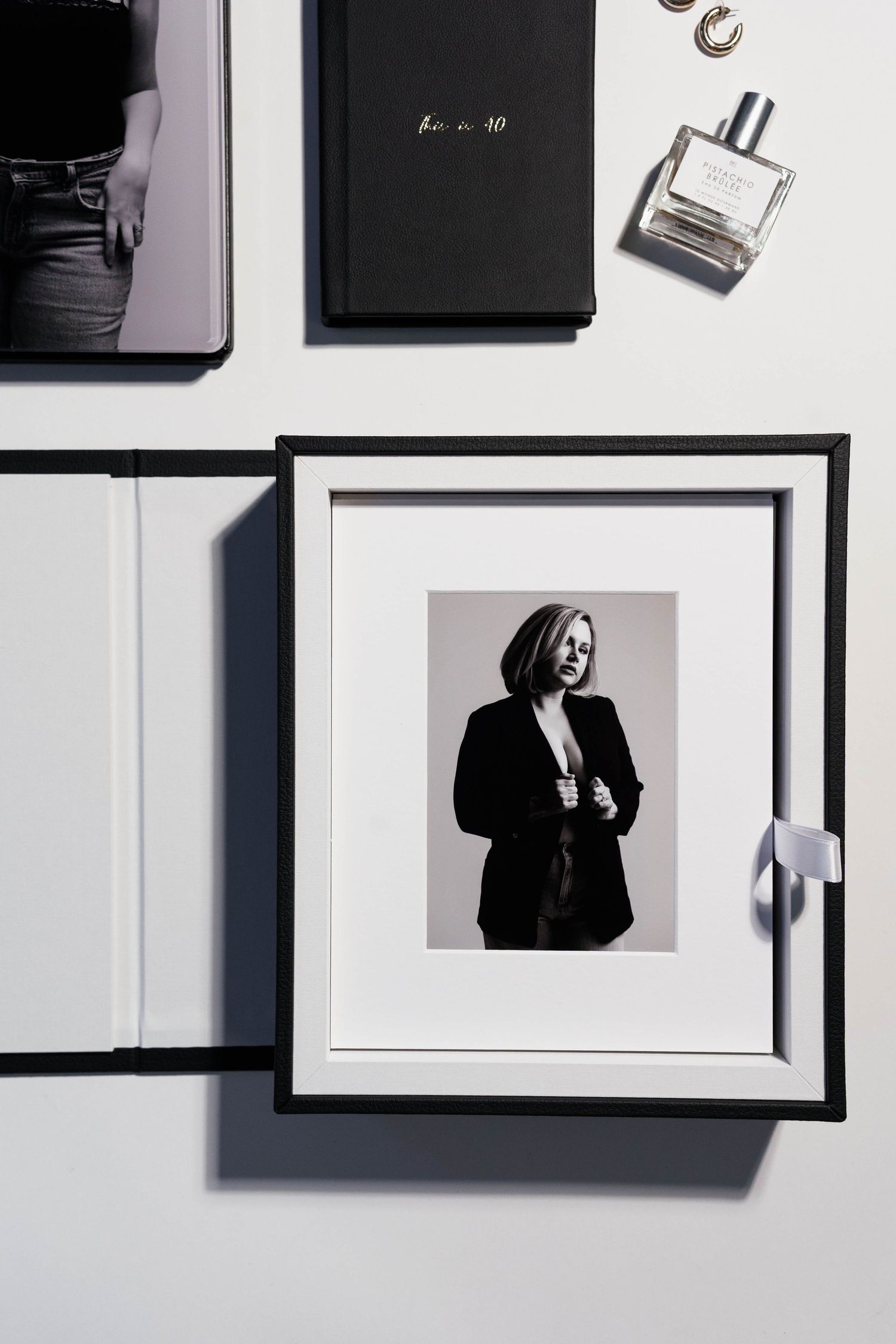 Professional photography branding layout with frames and perfume bottle on white surface.