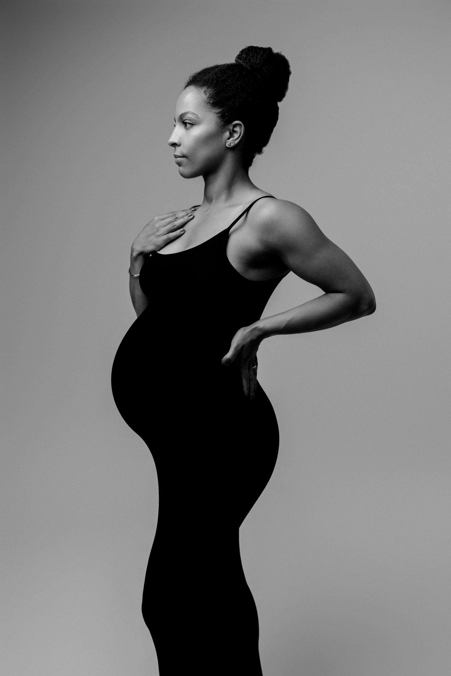 Black and white photo series showing artistic dance poses in silhouette against a minimalist gray background.