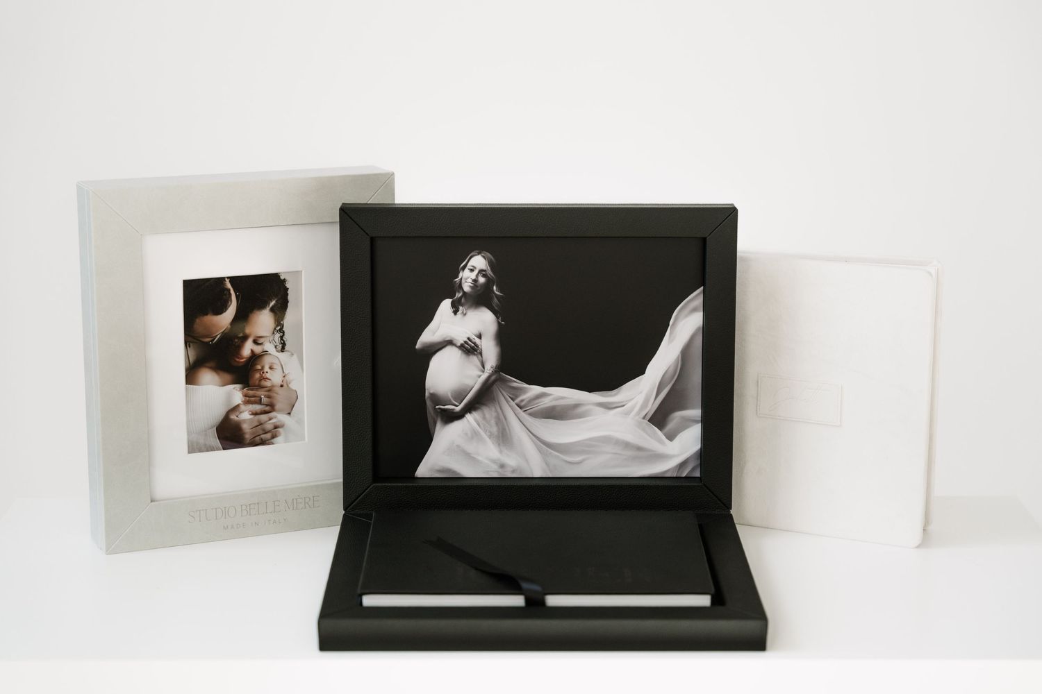 A series of black and white fine art photography prints displayed in an elegant presentation box.