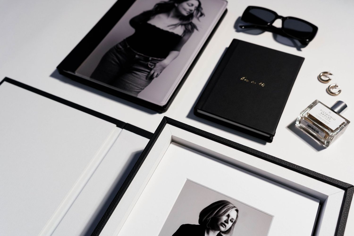 Minimalist product photography display featuring frames and branded materials.