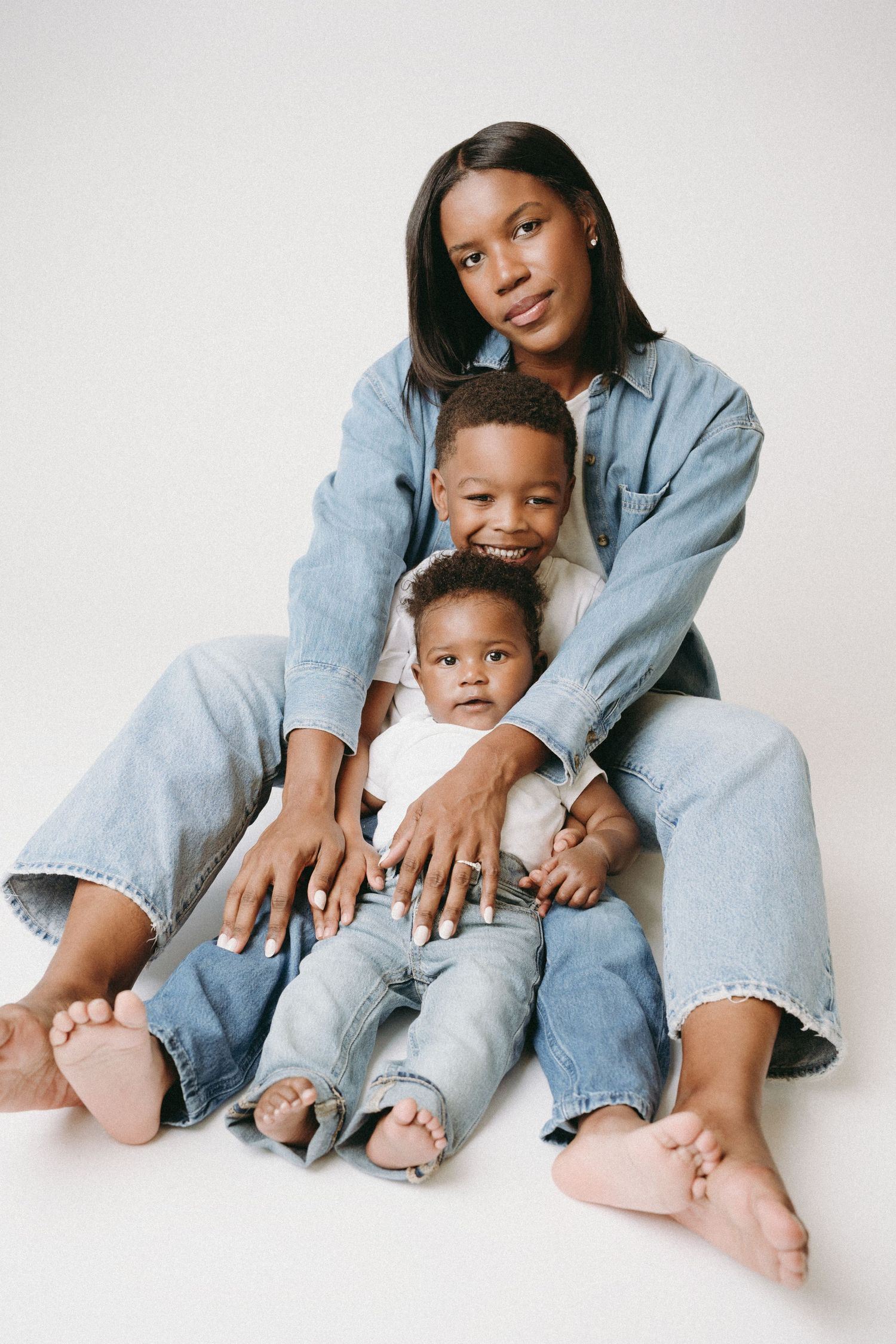 A series of intimate family portraits showing parent and child in matching denim against a white background.