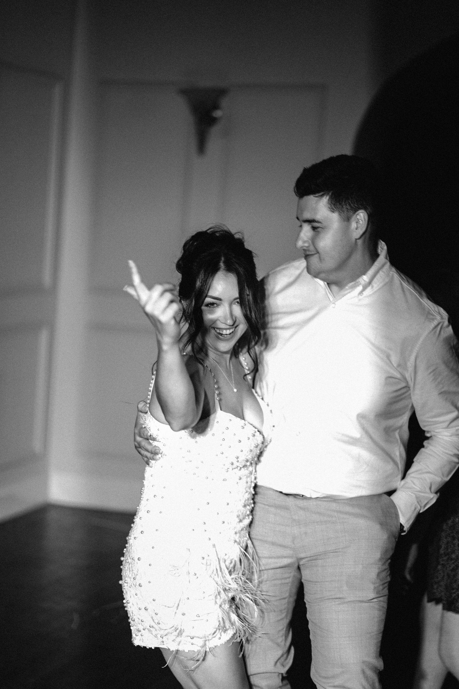 A black and white photo series shows a couple dancing together intimately in a romantic sequence.