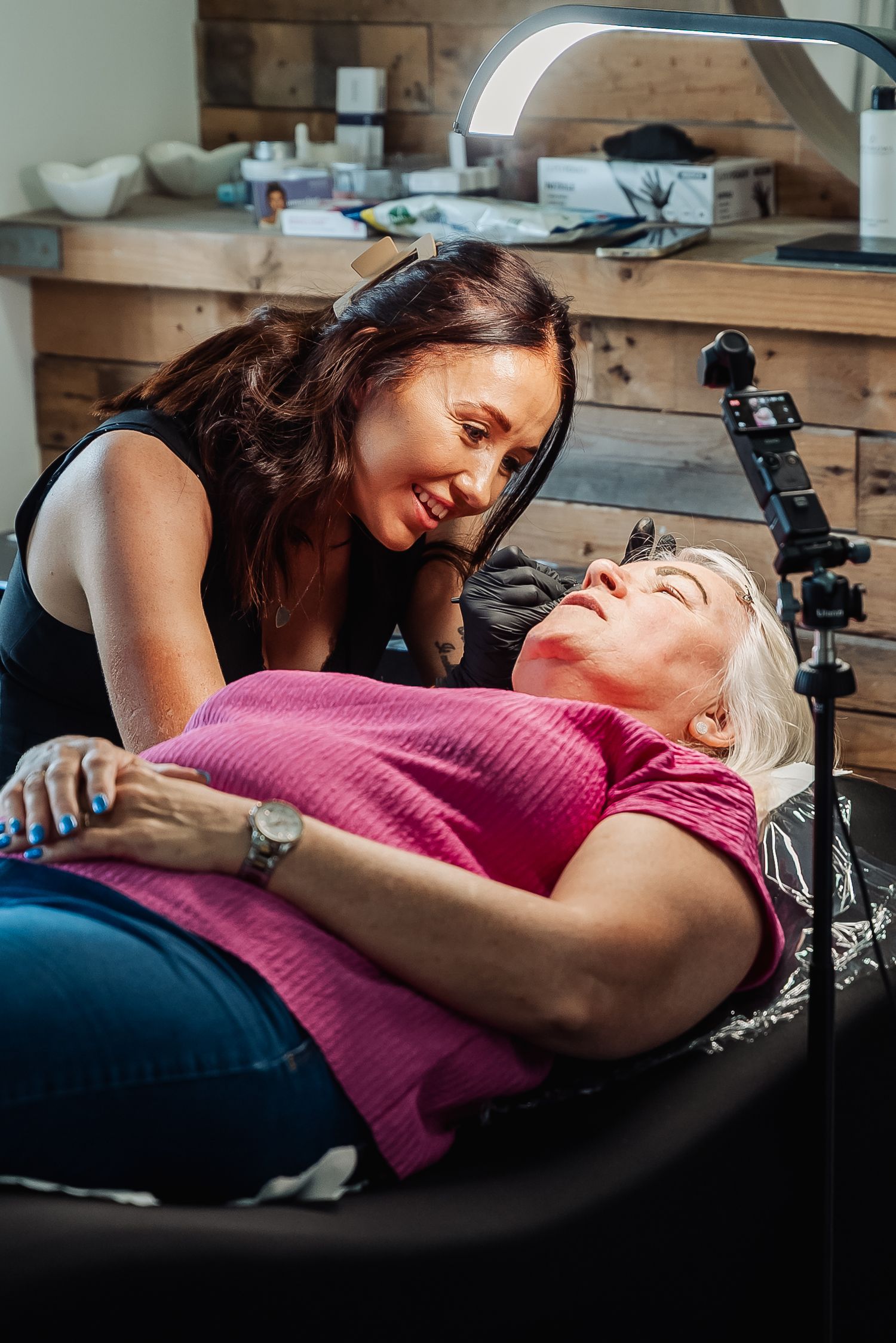 Two people sharing an intimate moment on a massage table in a spa setting.