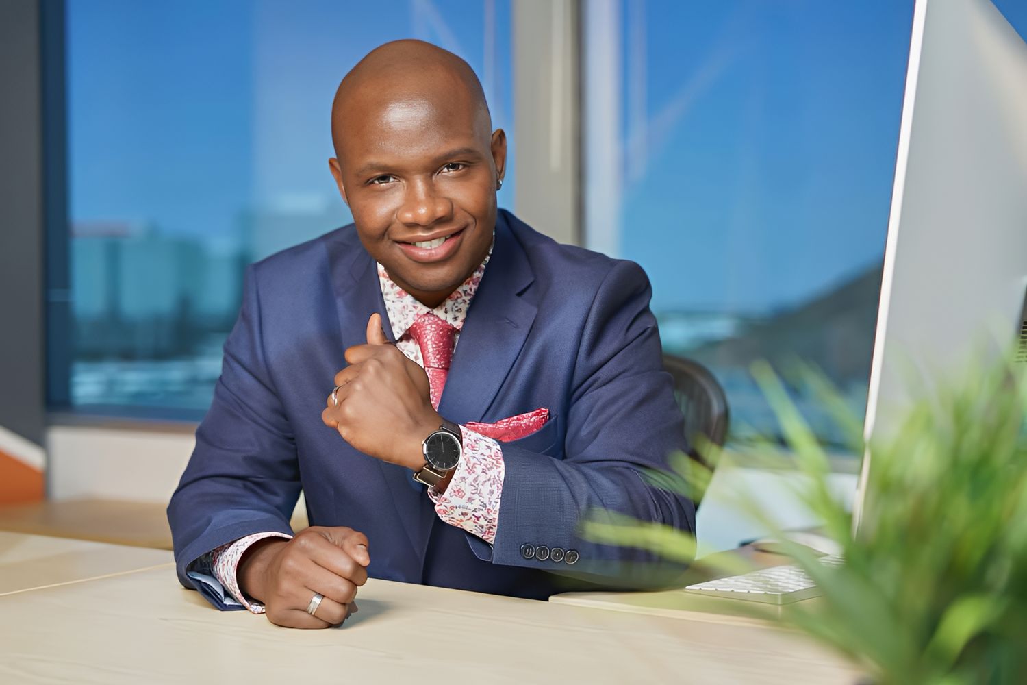 Business professional in dark suit smiling at camera. Photographer RL Davis