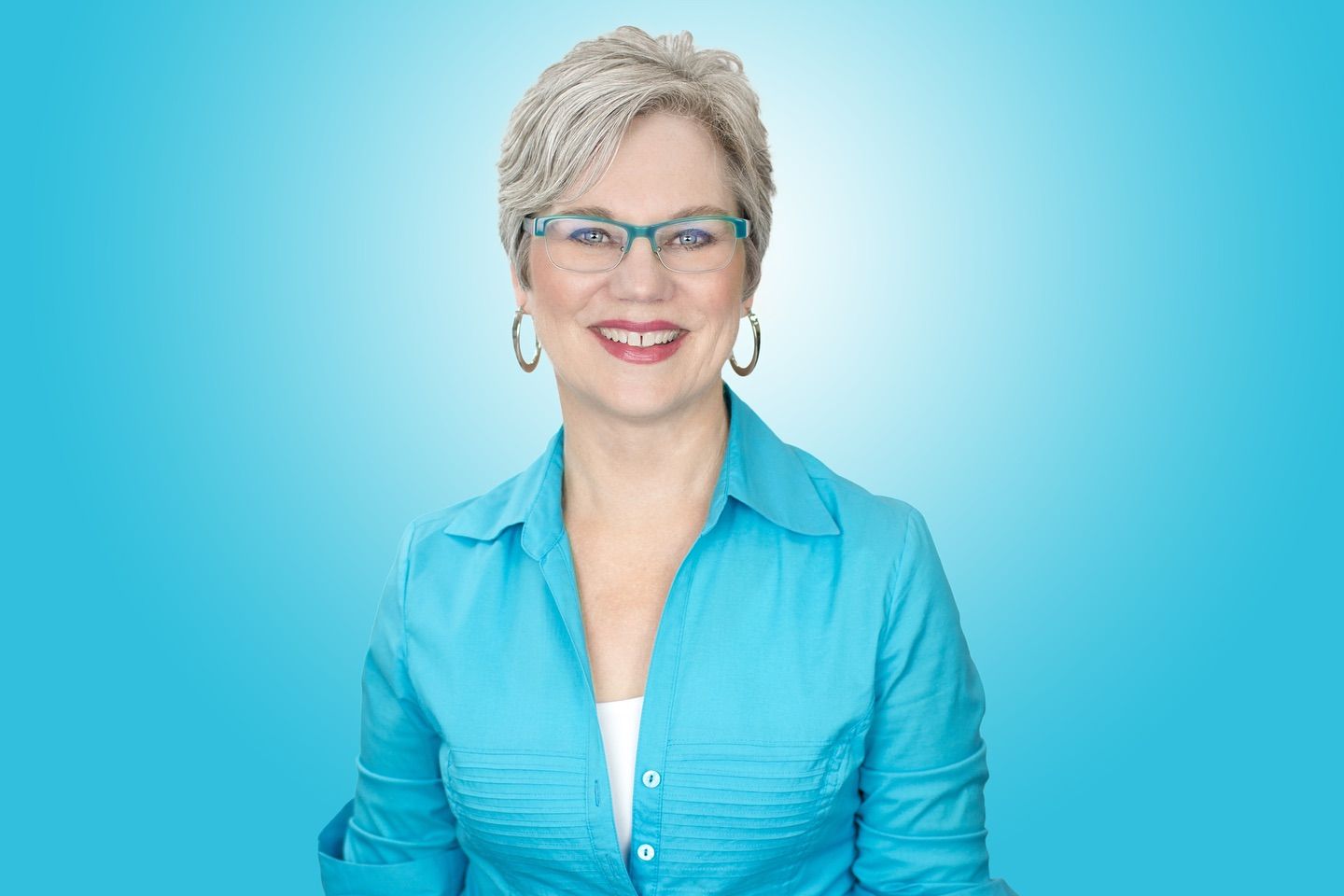Professional headshots against bright blue background wearing business attire. Photographer RL Davis