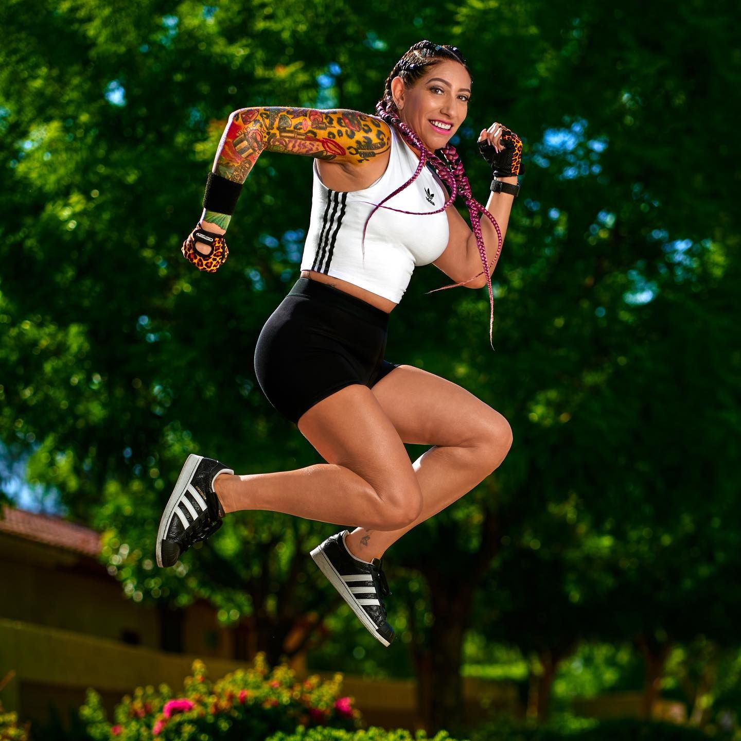 Athletic figure performing dynamic jumping poses in lush green outdoor setting. Photographer RL Davis