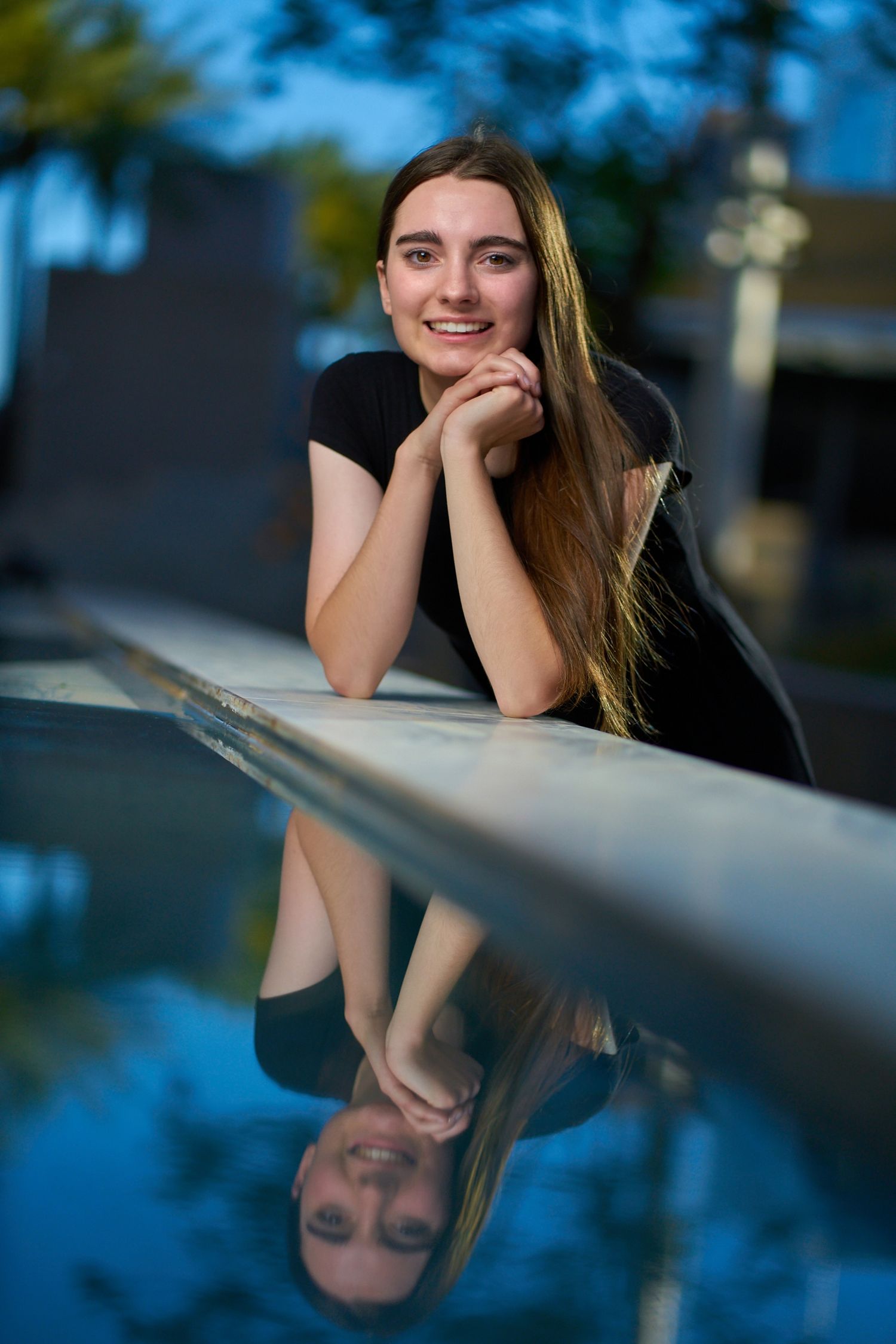 Artistic portrait series with reflective elements and blue sky background. Photographer RL Davis