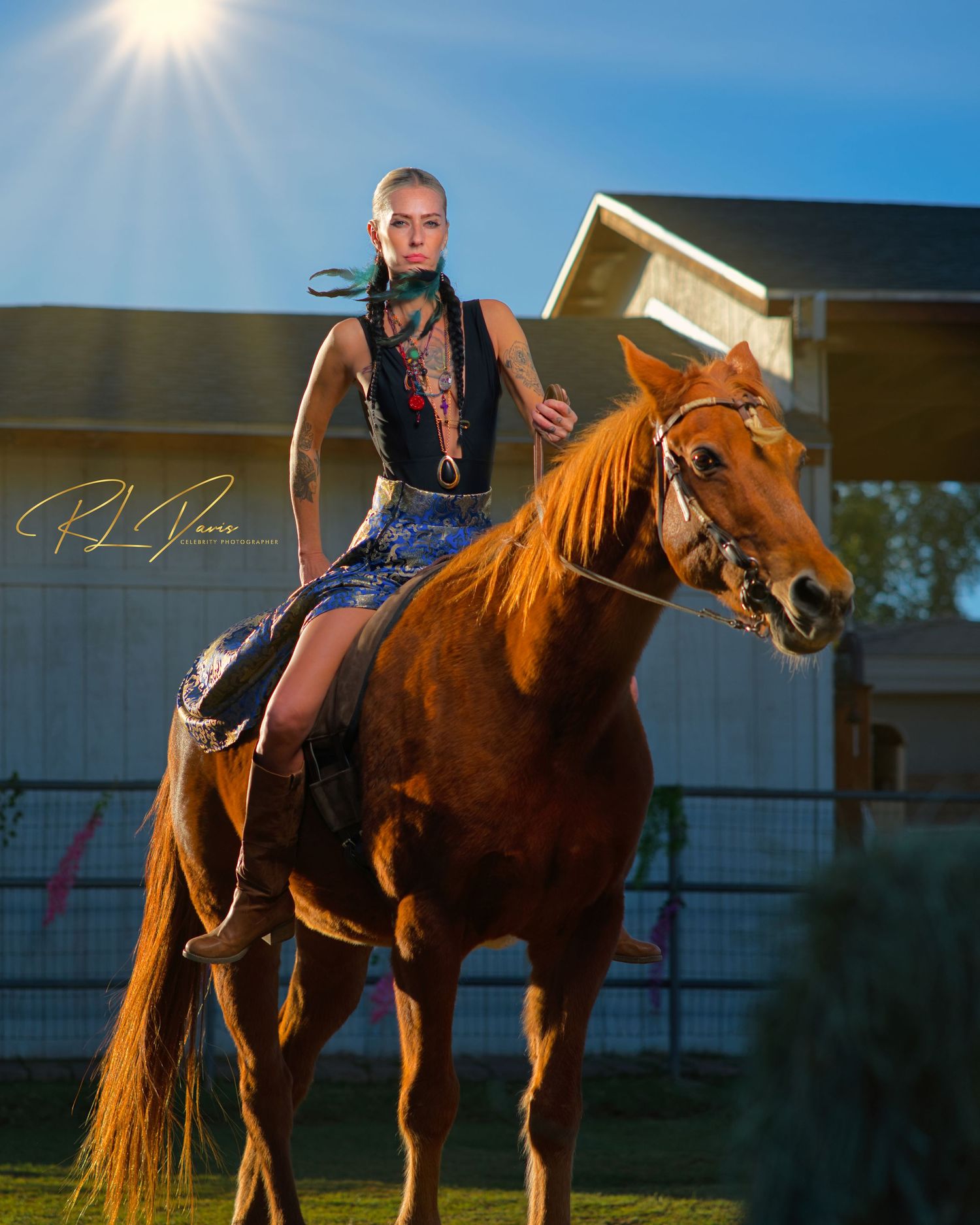 Horse and rider silhouetted against bright sunlight in outdoor arena. Photographer RL Davis