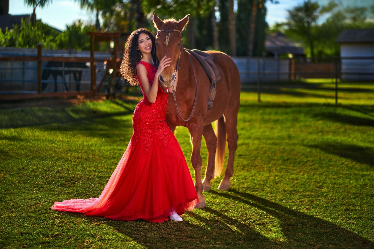 Miss Scottsdale Teen in A flowing red dress photographed in sequence against a sunlit grassy background. Photographer RL Davis