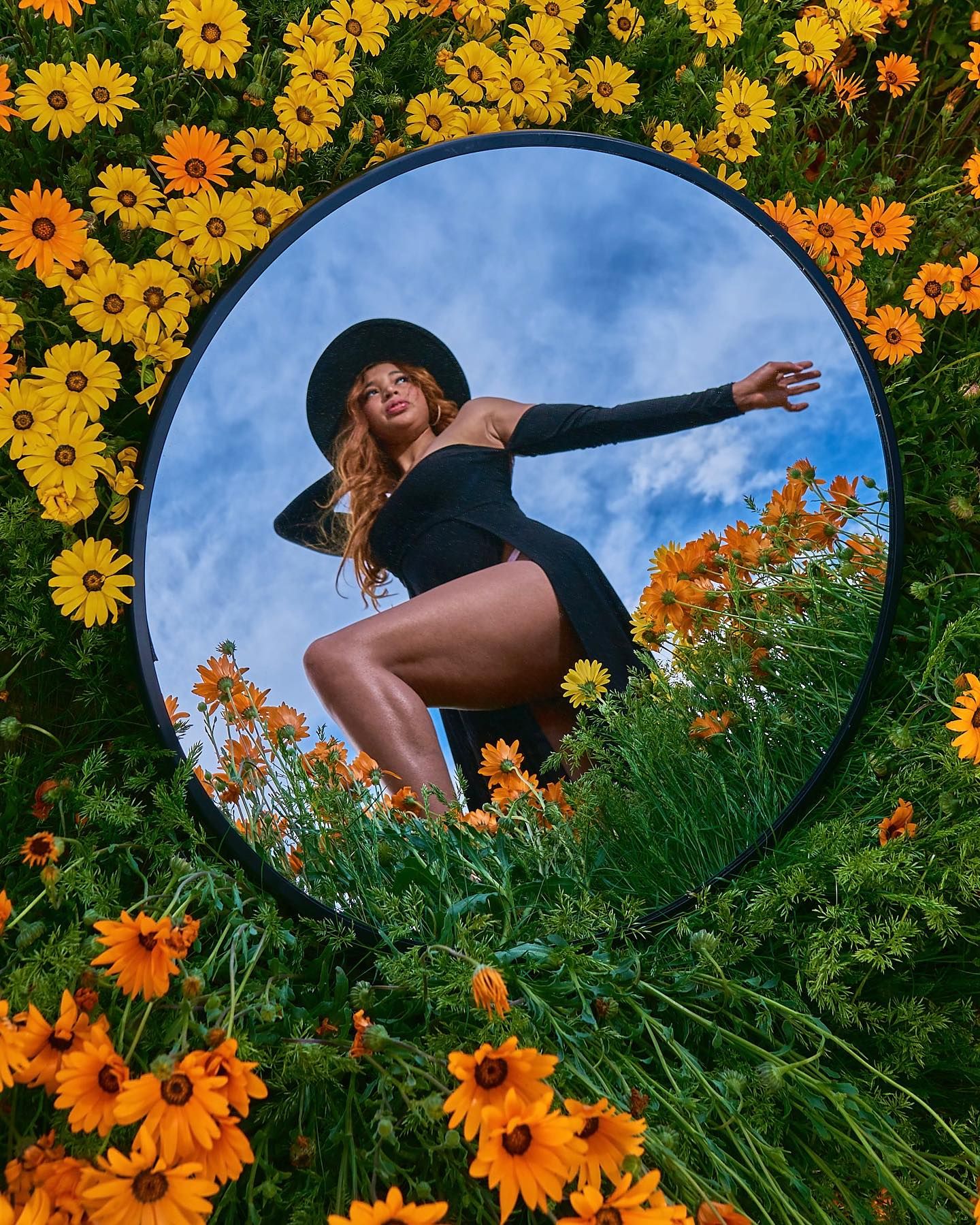 Creative mirror photography in sunflower garden capturing dance-like poses against blue sky. Photographer RL Davis