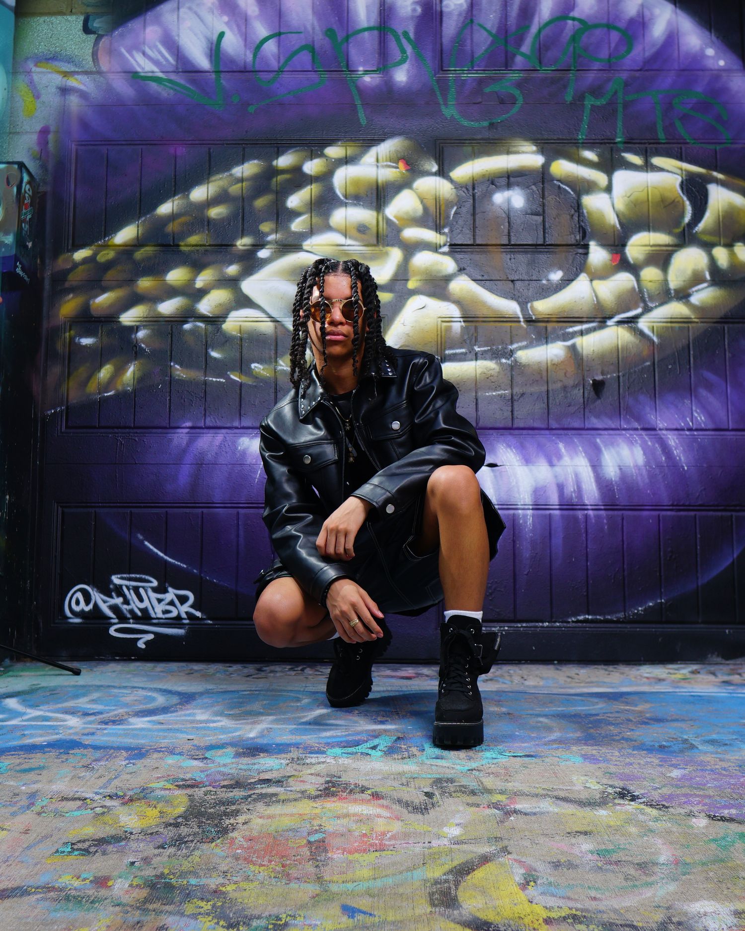 Urban fashion shoot against purple graffiti wall with dramatic lighting. Photographer RL Davis