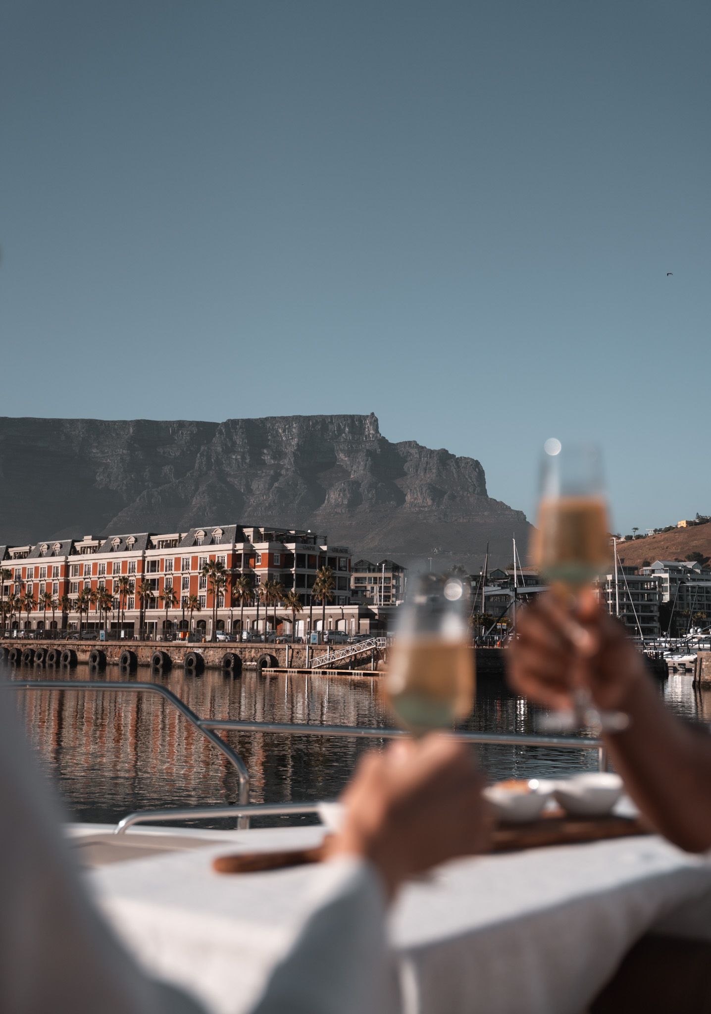 Enjoying cocktails with Table Mountain as backdrop at Cape Town's V&A Waterfront during sunset.