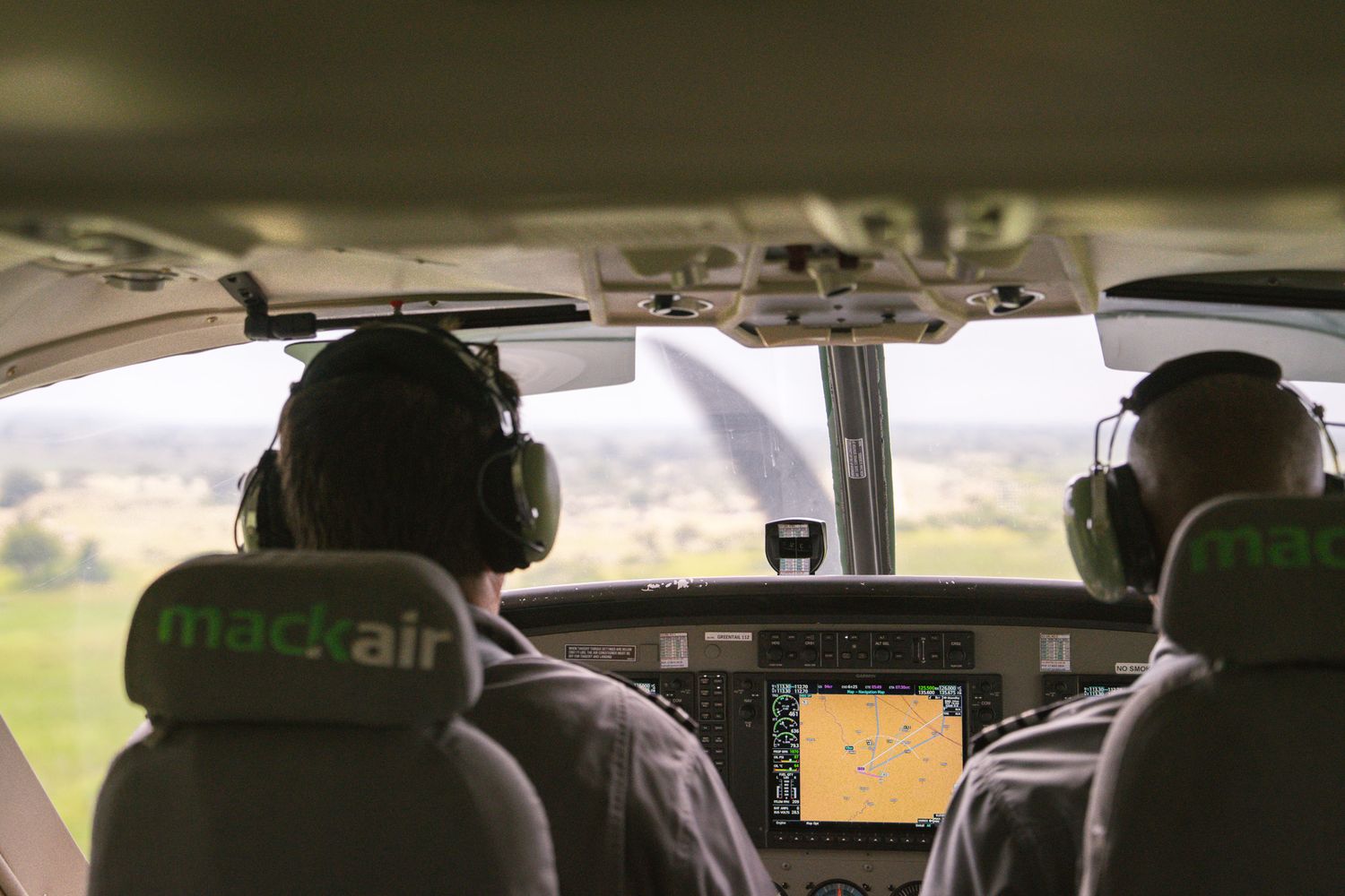 Interior view of an aircraft cockpit dashboard during flight.