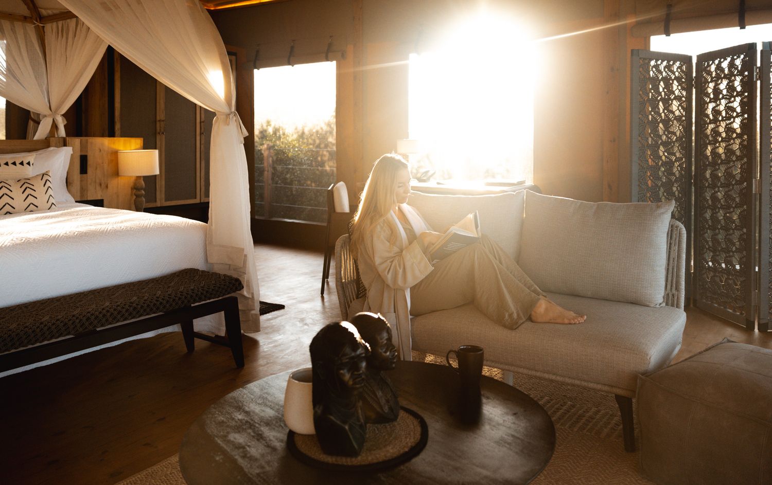 Cozy bedroom interior with natural sunlight streaming through windows.
