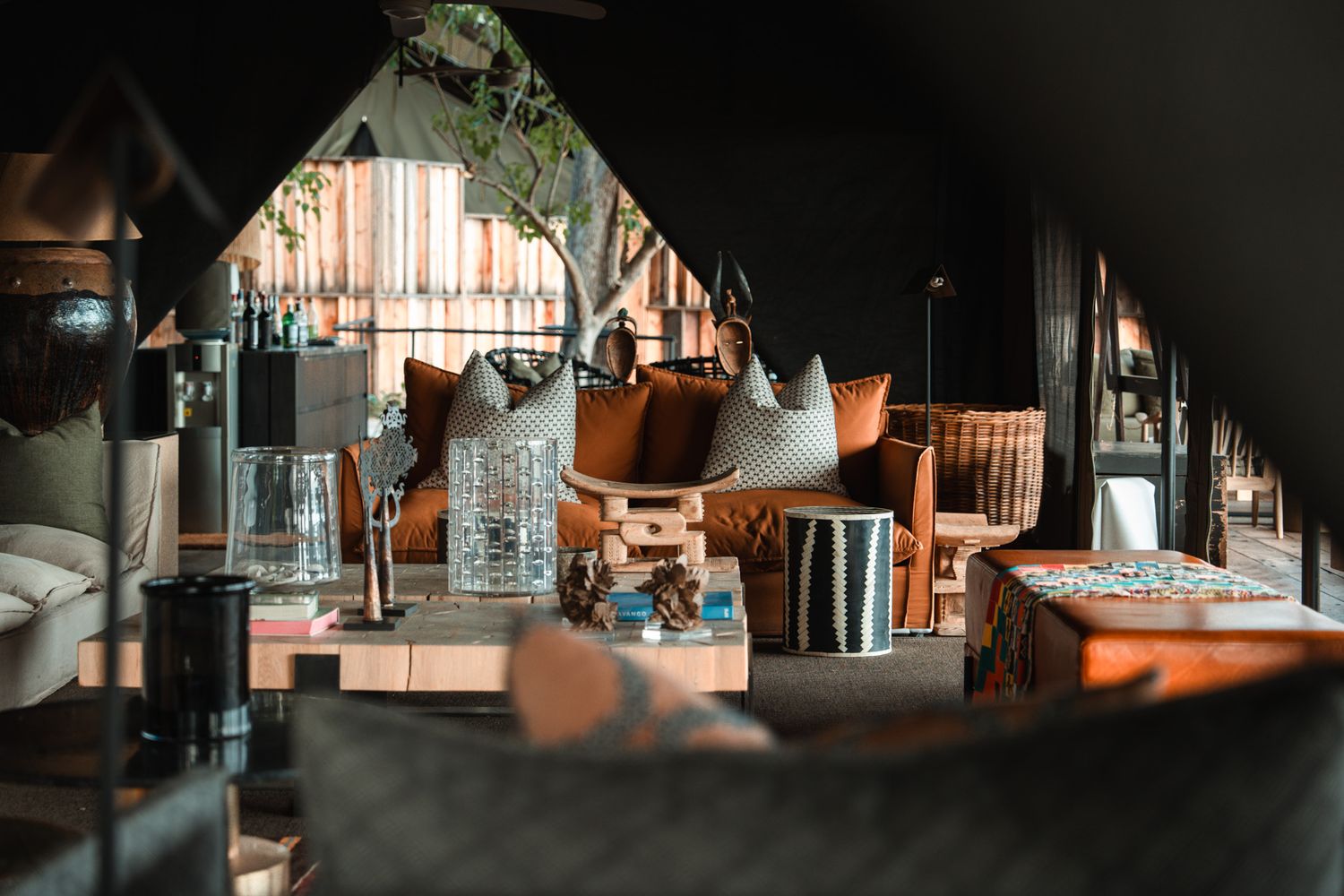 Moody interior of lodge-style accommodations with angled mirrors and copper accents.