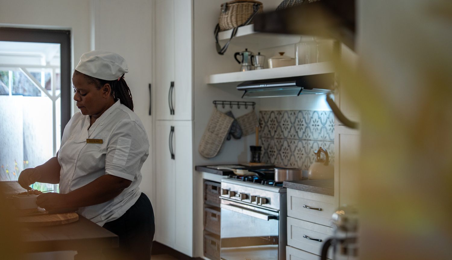 Chef working in a bright, modern professional kitchen.