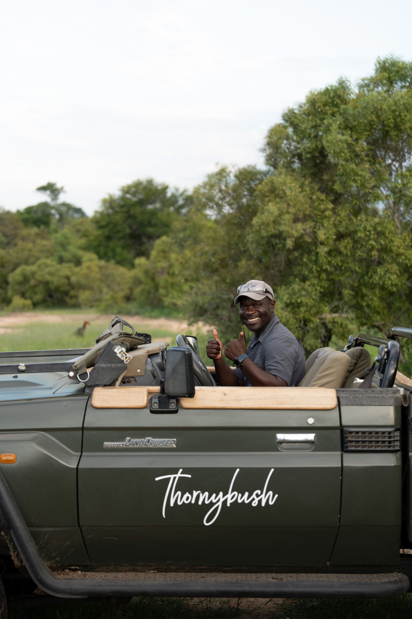 Safari vehicle marked 'Thornybush' parked in the African wilderness during a game drive.