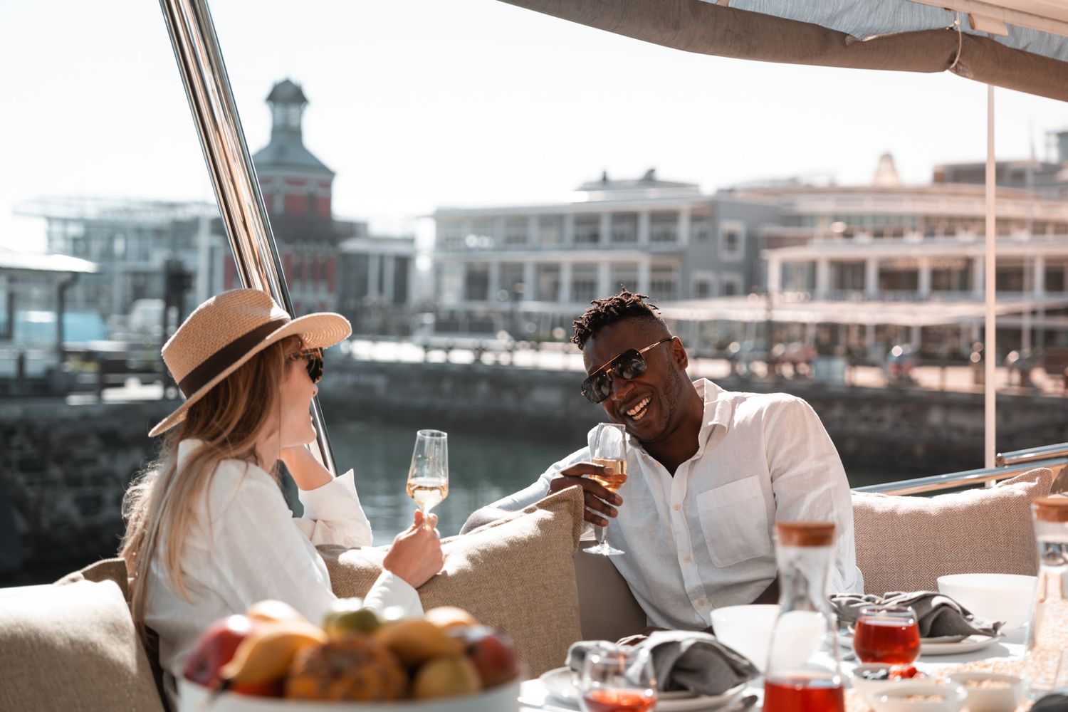 Scenic outdoor dining experience at a waterfront restaurant with drinks and snacks.