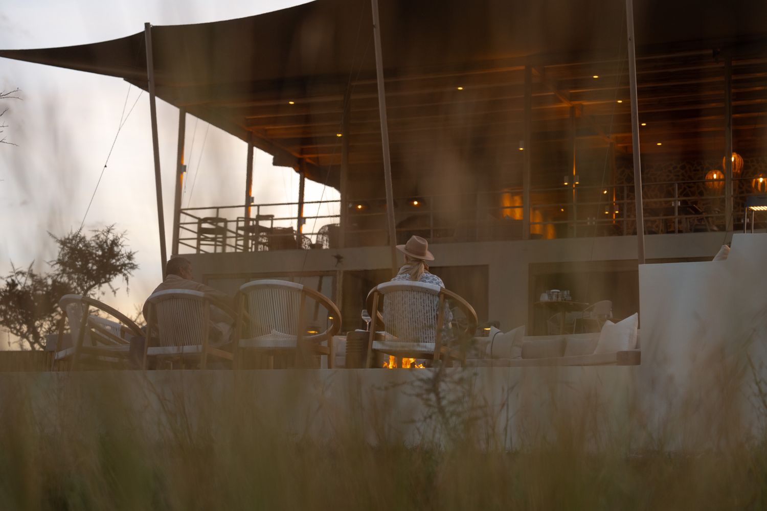 Atmospheric outdoor dining setup with ambient lighting at sunset.