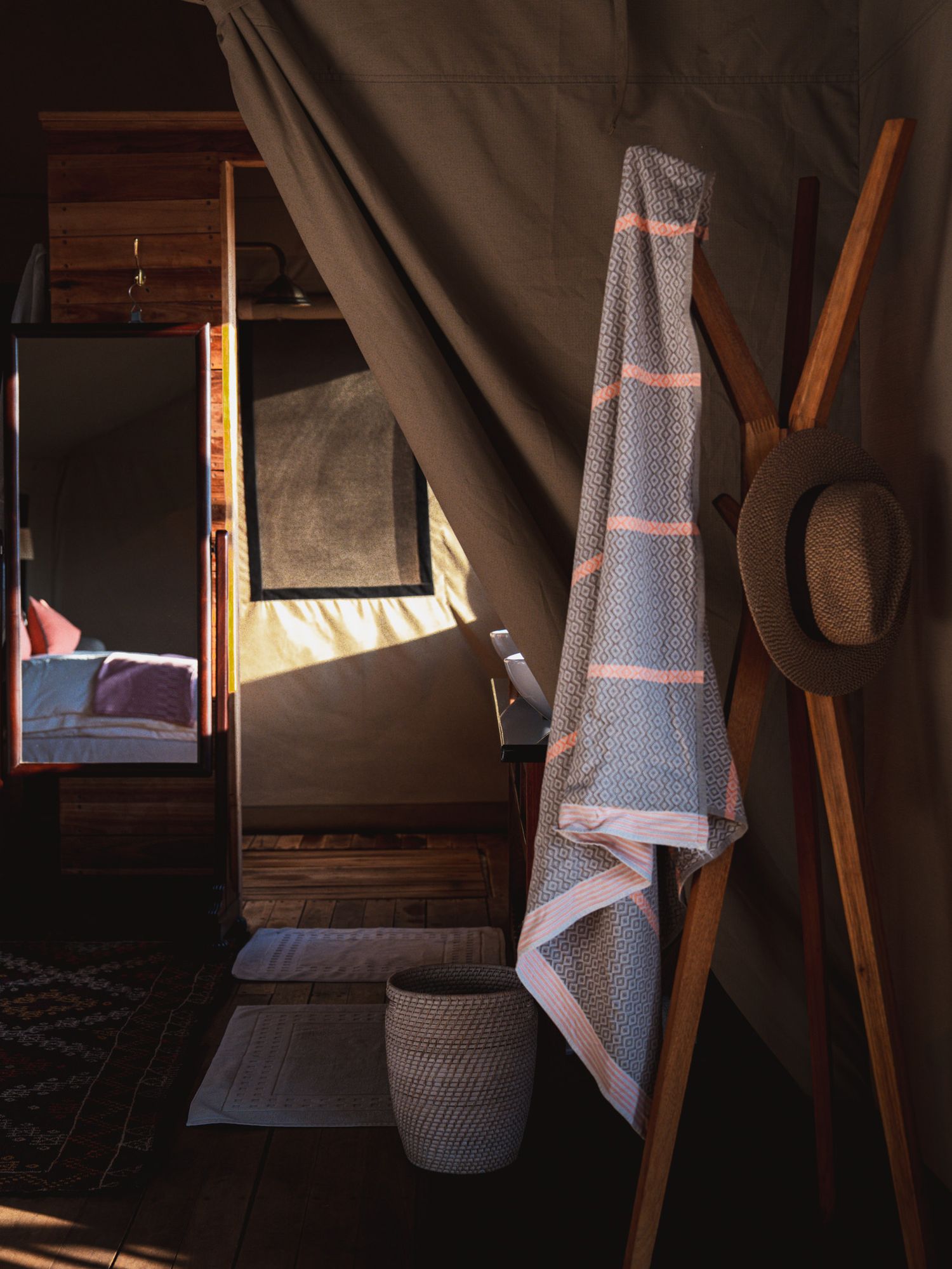 Rustic interior with draped textiles and wooden accents in warm natural lighting.