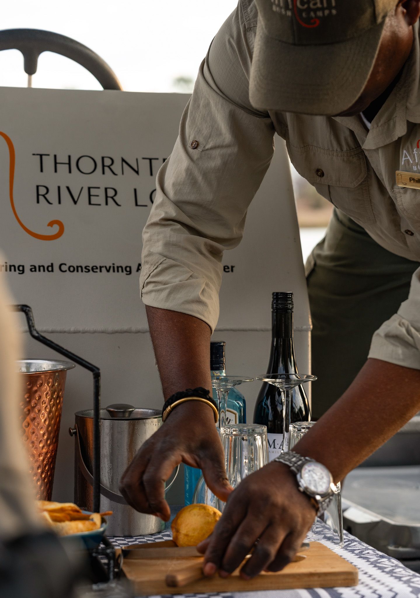 Bartender preparing drinks at Thornton River Lodge outdoor bar station.