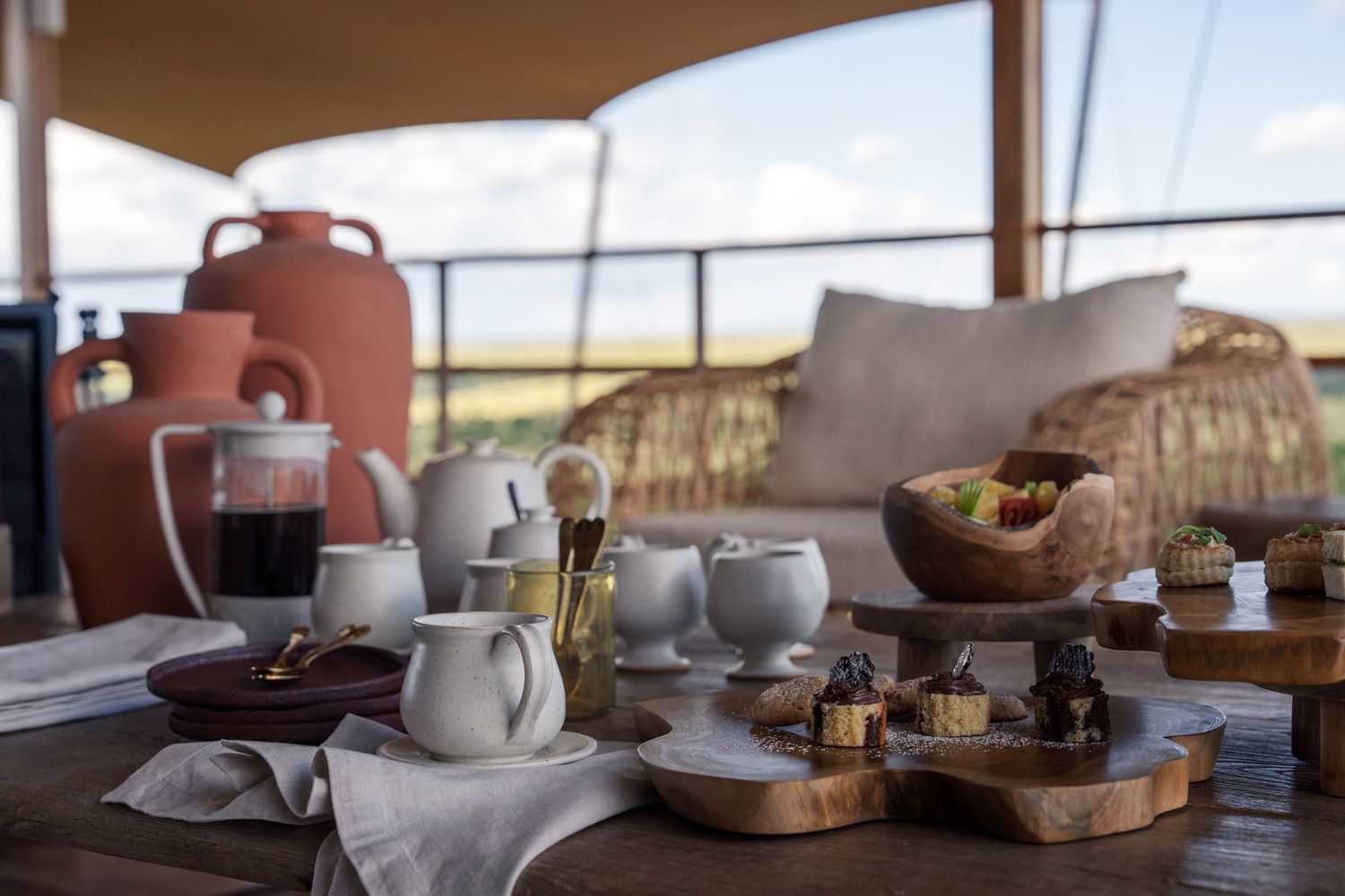 Rustic breakfast spread with coffee cups and pastries in natural lighting.