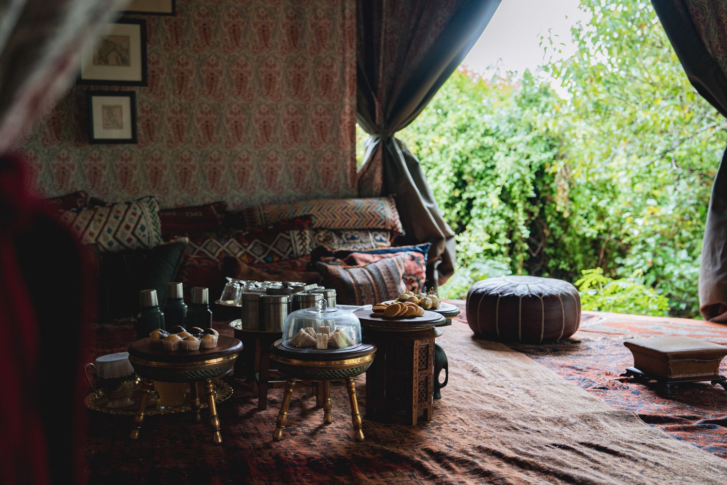 Cozy seating area under a canopy with patterned cushions and decorative elements.