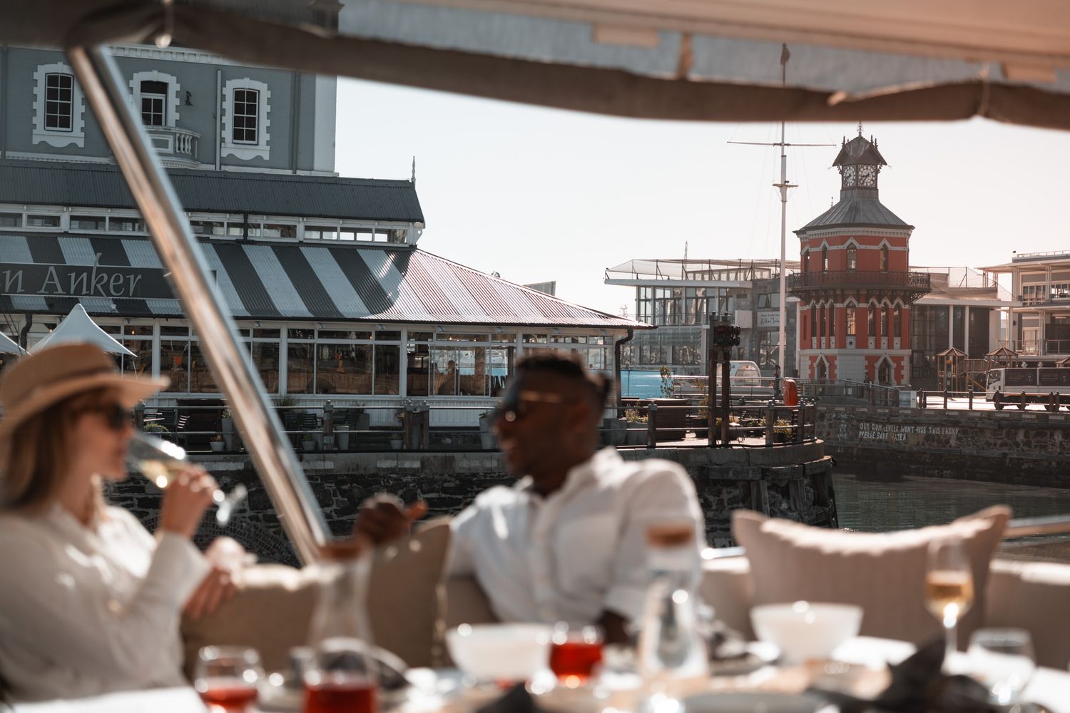 Scenic waterfront dining experience with historic architecture visible in the background.