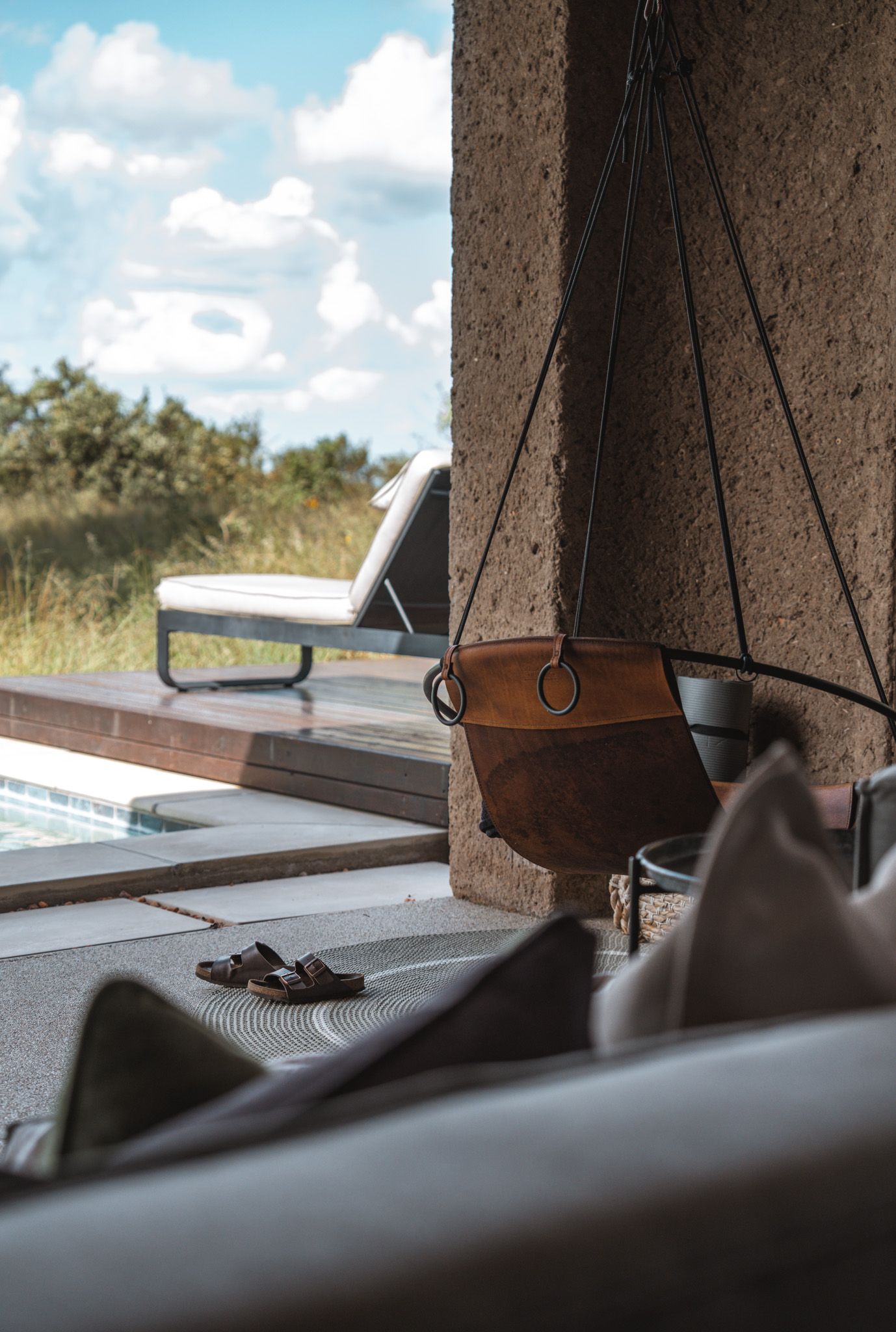 Hanging lamps and decor elements photographed against a bright window in rustic interior.