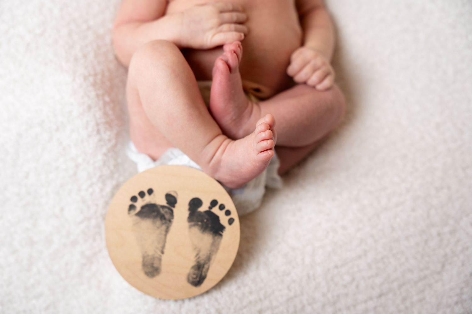 Series of baby footprint impressions in clay showing different angles and details.