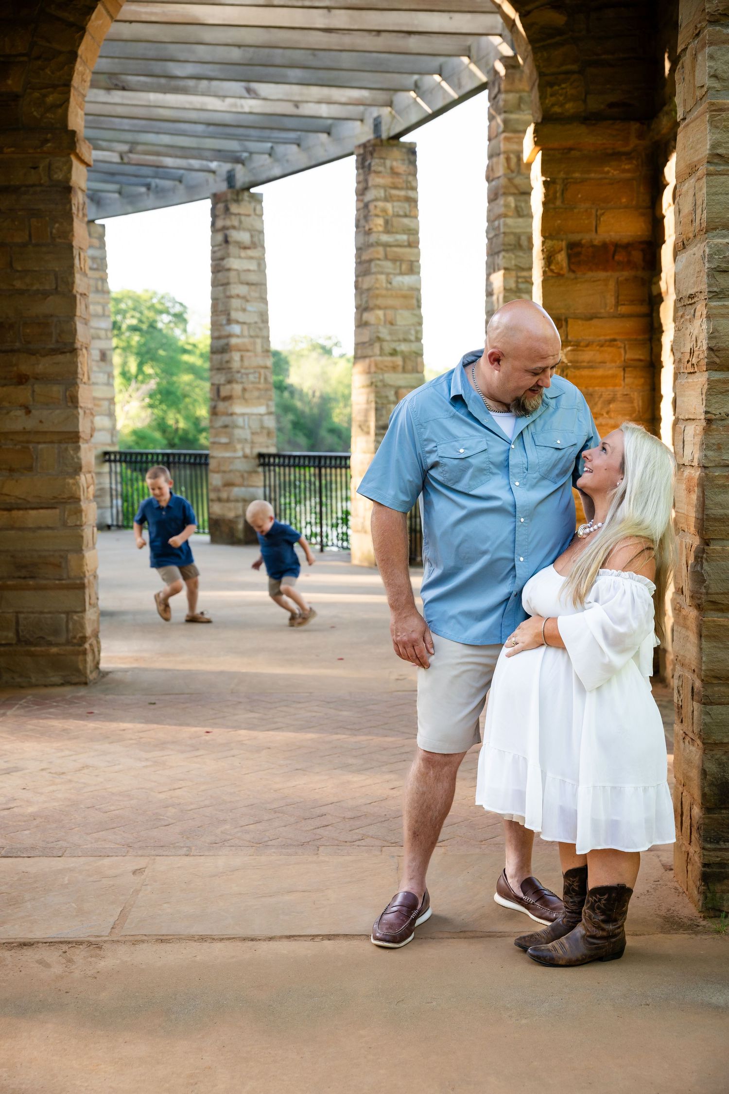 Stone colonnade walkway setting for family portraits with architectural elements.